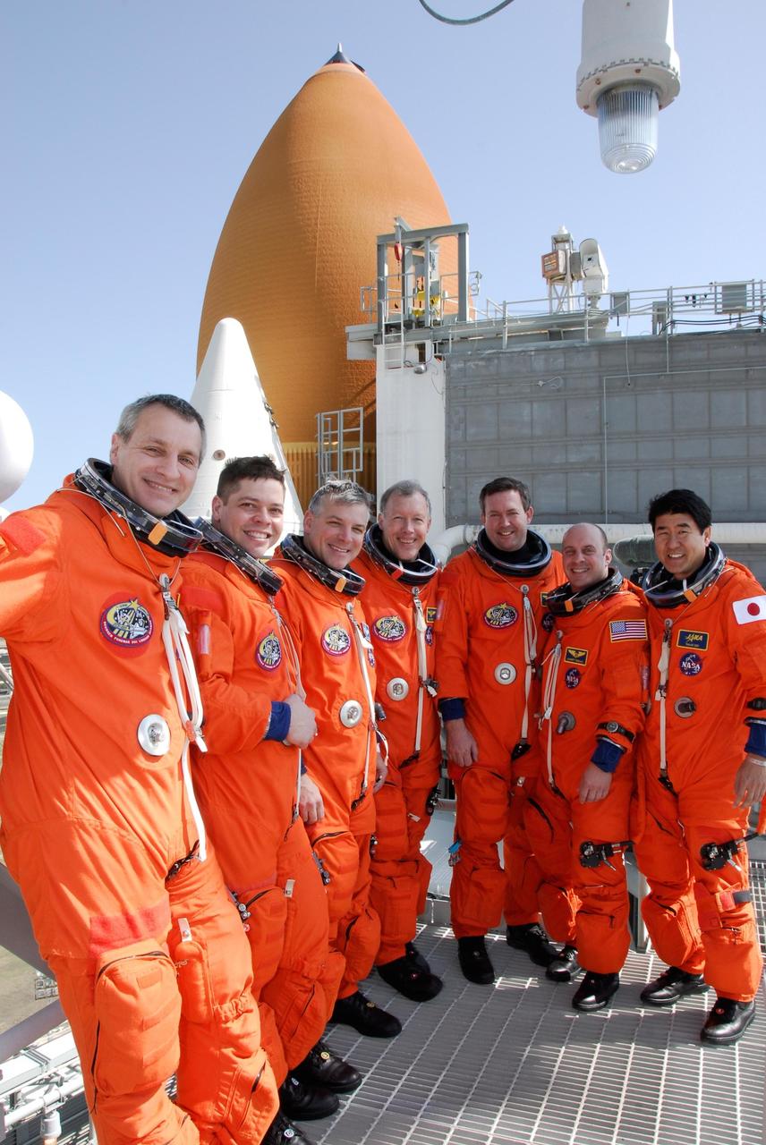 KENNEDY SPACE CENTER, FLA. -- Gathered again on the top level of the fixed service structure, the STS-123 crew poses for a photo after completing the simulated launch countdown. From left are Mission Specialists Rick Linnehan and Robert L. Behnken, Pilot Gregory H. Johnson, Commander Dominic Gorie, and Mission Specialists Mike Foreman, Garrett Reisman and Takao Doi. The countdown was the culmination of the terminal countdown demonstration test, or TCDT. The TCDT provides astronauts and ground crews with an opportunity to participate in various countdown activities, including equipment familiarization and emergency egress training. Endeavour is targeted to launch at 2:28 a.m. EDT March 11 on the 16-day STS-123 mission to the International Space Station. Endeavour and its crew will deliver the first section of the Japan Aerospace Exploration Agency's Kibo laboratory and the Canadian Space Agency's two-armed robotic system, Dextre. Photo credit: NASA/Kim Shiflett