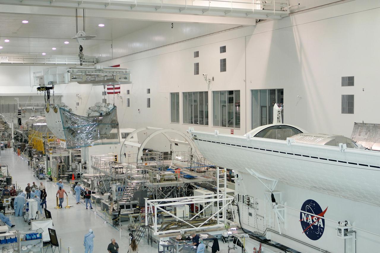 KENNEDY SPACE CENTER, FLA. -- In the Space Station Processing Facility at NASA's Kennedy Space Center, the Special Purpose Dexterous Manipulator, known as Dextre, moves across the facility via an overhead crane to the payload canister at right for transfer to Launch Pad 39A. Dextre is a sophisticated dual-armed robot, which is part of Canada's contribution to the International Space Station. Along with Canadarm2, which is called the Space Station Remote Manipulator System, and a moveable work platform called the Mobile Base System, these three elements form a robotic system called the Mobile Servicing System. The three components have been designed to work together or independently. Dextre is part of the payload on space shuttle Endeavour's STS-123 mission, targeted for launch March 11. Photo courtesy of The Boeing Company