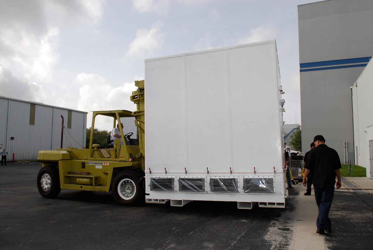 KENNEDY SPACE CENTER, FLA. --  The shipping container holding NASA's Gamma-Ray Large Area Space Telescope, or GLAST, is removed from the truck at the Astrotech payload processing facility near the Kennedy Space Center to begin prelaunch activities. The GLAST will launch aboard a Delta II rocket May 16 from Launch Pad 17-B on Cape Canaveral Air Force Station.  A powerful space observatory, the GLAST will explore the most extreme environments in the universe, and answer questions about supermassive black hole systems, pulsars and the origin of cosmic rays. It also will study the mystery of powerful explosions known as gamma-ray bursts.  Photo credit: NASA/Kim Shiflett