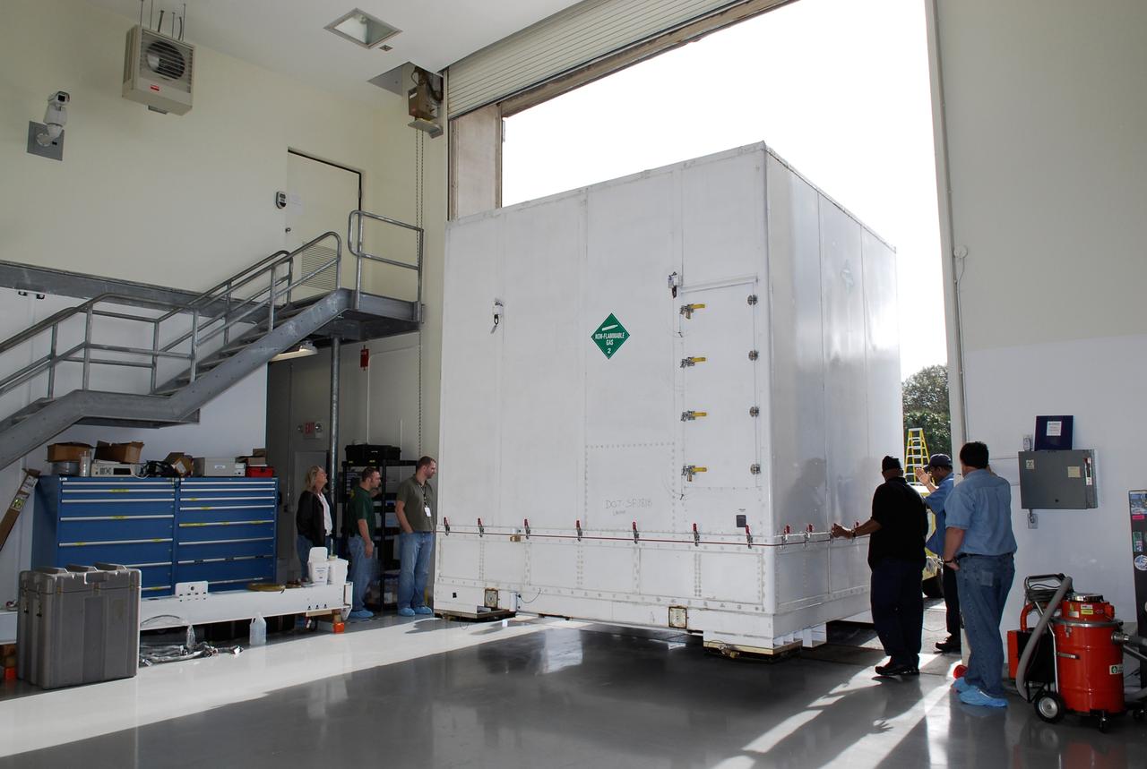 KENNEDY SPACE CENTER, FLA. --  The shipping container holding NASA's Gamma-Ray Large Area Space Telescope, or GLAST, is moved into the Astrotech payload processing facility near the Kennedy Space Center to begin prelaunch activities. The GLAST will launch aboard a Delta II rocket May 16 from Launch Pad 17-B on Cape Canaveral Air Force Station.  A powerful space observatory, the GLAST will explore the most extreme environments in the universe, and answer questions about supermassive black hole systems, pulsars and the origin of cosmic rays. It also will study the mystery of powerful explosions known as gamma-ray bursts.  Photo credit: NASA/Kim Shiflett