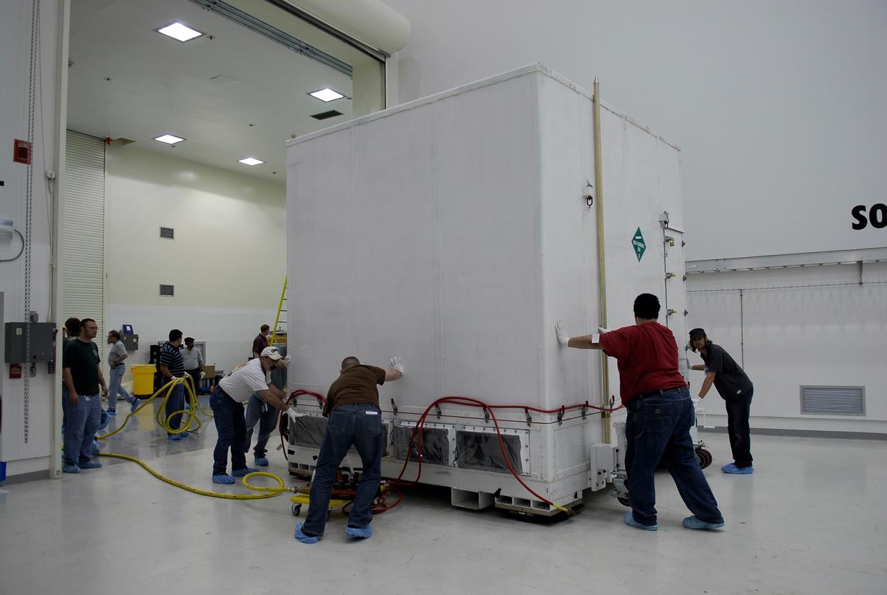 KENNEDY SPACE CENTER, FLA. --  In the Astrotech payload processing facility near the Kennedy Space Center, workers maneuver the shipping container holding NASA's Gamma-Ray Large Area Space Telescope, or GLAST, into place. The GLAST will launch aboard a Delta II rocket May 16 from Launch Pad 17-B on Cape Canaveral Air Force Station.  A powerful space observatory, the GLAST will explore the most extreme environments in the universe, and answer questions about supermassive black hole systems, pulsars and the origin of cosmic rays. It also will study the mystery of powerful explosions known as gamma-ray bursts.  Photo credit: NASA/Kim Shiflett
