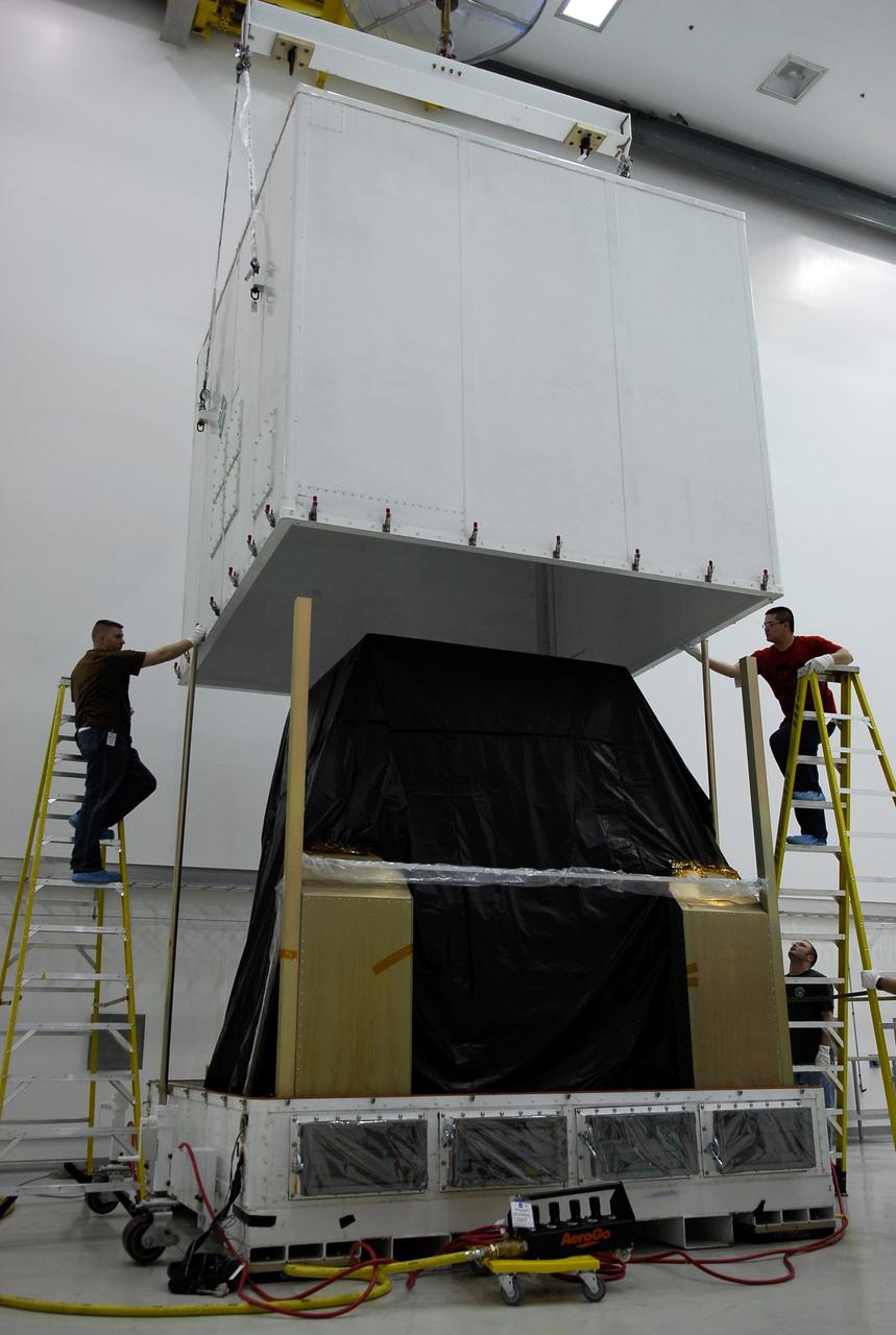 KENNEDY SPACE CENTER, FLA. --  In the Astrotech payload processing facility near the Kennedy Space Center, the shipping container covering NASA's Gamma-Ray Large Area Space Telescope, or GLAST, is lifted to reveal the protected equipment inside.  Workers will prepare for a complete checkout of the telescope's scientific instruments. The GLAST will launch aboard a Delta II rocket May 16 from Launch Pad 17-B on Cape Canaveral Air Force Station.  A powerful space observatory, the GLAST will explore the most extreme environments in the universe, and answer questions about supermassive black hole systems, pulsars and the origin of cosmic rays. It also will study the mystery of powerful explosions known as gamma-ray bursts.  Photo credit: NASA/Kim Shiflett
