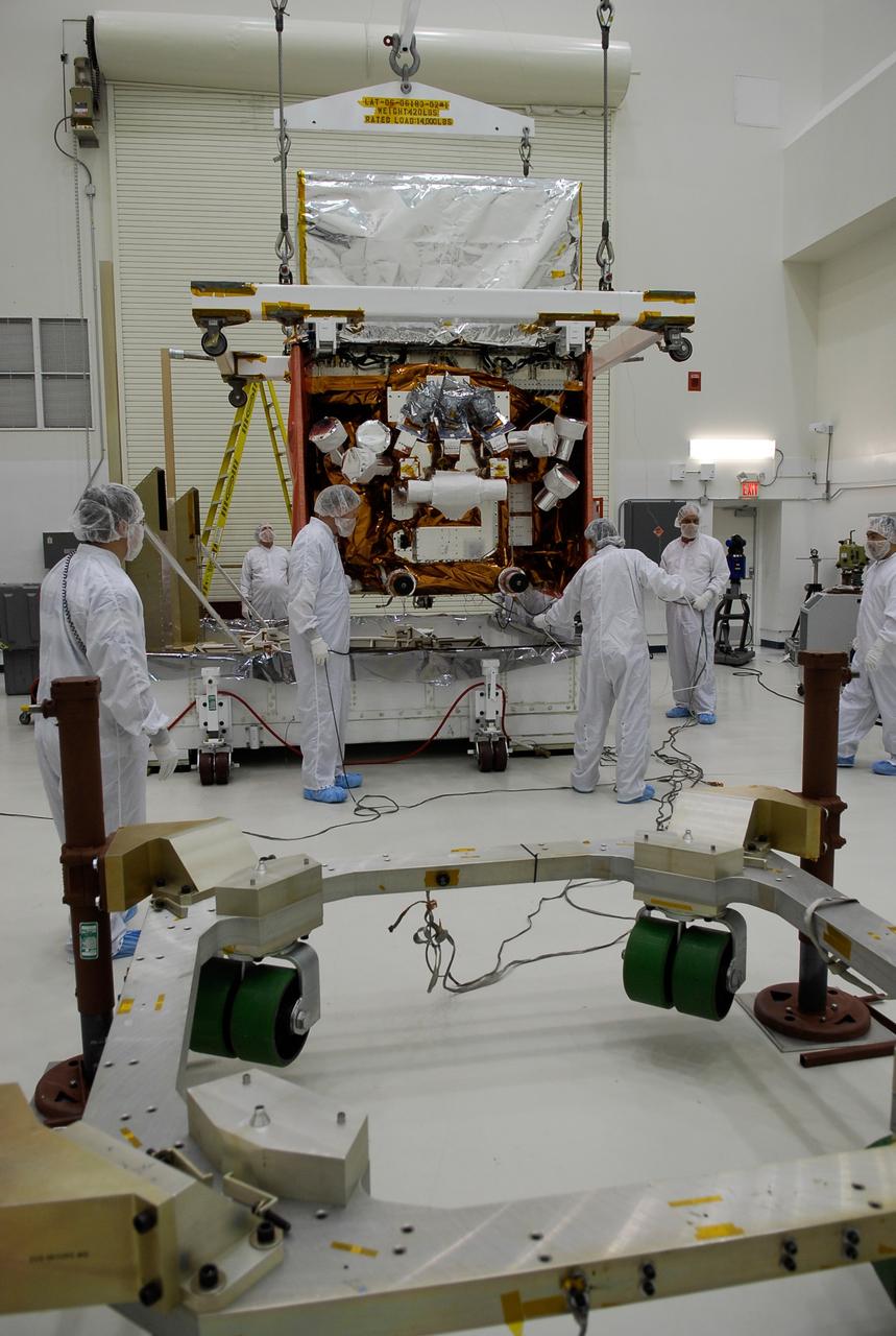 KENNEDY SPACE CENTER, FLA. -- In the Astrotech payload processing facility, General Dynamics technicians keep watch as NASA's Gamma-Ray Large Area Space Telescope, or GLAST, is lifted and begins moving toward the work stand in the foreground. There GLAST will undergo a complete checkout of the scientific instruments aboard. The telescope will launch aboard a Delta II rocket May 16 from Launch Pad 17-B on Cape Canaveral Air Force Station. A powerful space observatory, the GLAST will explore the most extreme environments in the universe, and answer questions about supermassive black hole systems, pulsars and the origin of cosmic rays. It also will study the mystery of powerful explosions known as gamma-ray bursts. Photo credit: NASA/Kim Shiflett