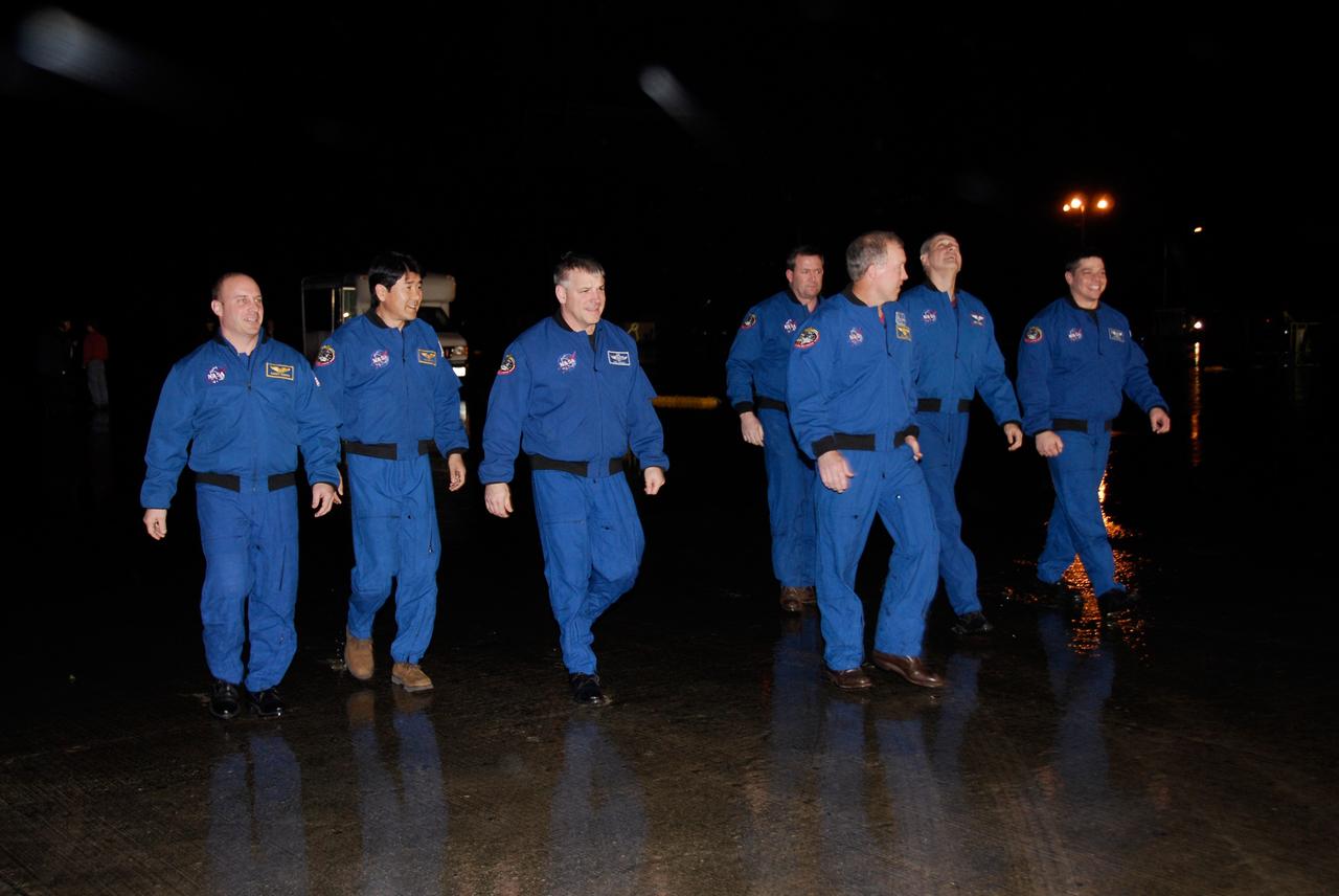 KENNEDY SPACE CENTER, FLA. -- The crew members of space shuttle Endeavour's STS-123 mission prepare to address the media representatives on hand for their arrival at NASA Kennedy Space Center's Shuttle Landing Facility. Launch is set for 2:28 a.m. EDT on March 11. From left are Mission Specialists Garrett Reisman, who will remain on the International Space Station as a flight engineer, and Takao Doi of the Japan Aerospace Exploration Agency; Pilot Gregory H. Johnson; Mission Specialist Mike Foreman; Commander Dominic Gorie; and Mission Specialists Rick Linnehan and Robert L. Behnken. On this mission to the International Space Station, Endeavour and its crew will deliver the first section of the Japan Aerospace Exploration Agency's Kibo laboratory and the Canadian Space Agency's two-armed robotic system, Dextre. Photo credit: NASA/Kim Shiflett