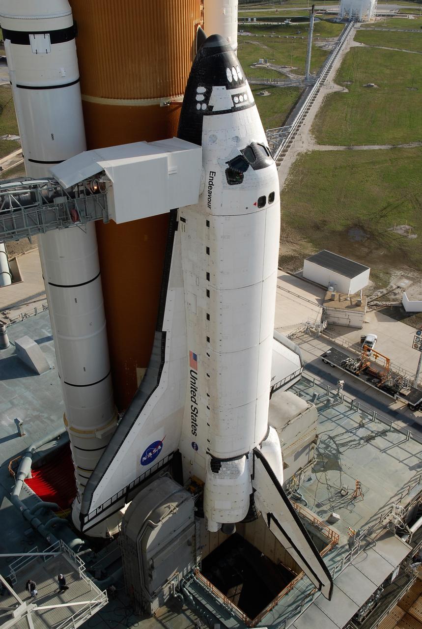 KENNEDY SPACE CENTER, FLA. -- With the rotating service structure rolled away on Launch Pad 39A at NASA's Kennedy Space Center, space shuttle Endeavour is in full view. First motion was at 8:23 a.m. and rollback was complete at 8:55 a.m. Extending toward Endeavour from the left is the orbiter access arm with the White Room at the end, flush against the shuttle. The crew gains access into the orbiter through the White Room. The rotating structure provides protected access to the orbiter for changeout and servicing of payloads at the pad. The structure is supported by a rotating bridge that pivots about a vertical axis on the west side of the pad's flame trench. After the RSS is rolled back, the orbiter is ready for fuel cell activation and external tank cryogenic propellant loading operations. The pad is cleared to the perimeter gate for operations to fill the external tank with about 500,000 gallons of cryogenic propellants used by the shuttle’s main engines. This is done at the pad approximately eight hours before the scheduled launch. Endeavour and its crew will deliver the first section of the Japan Aerospace Exploration Agency's Kibo laboratory and the Canadian Space Agency's two-armed robotic system, Dextre. Launch is scheduled for 2:28 a.m. EDT March 11. Photo credit: NASA/Kim Shiflett