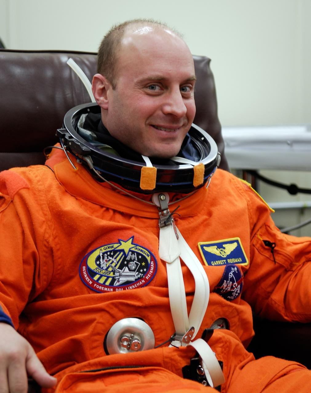 KENNEDY SPACE CENTER, FLA. -- STS-123 Mission Specialist Garrett Reisman dons his launch and entry suit before heading to Launch Pad 39A for liftoff on space shuttle Endeavour. Reisman will remain on the International Space Station as a flight engineer. The crew will make a record-breaking 16-day mission to the International Space Station. On STS-123, Endeavour and its crew will deliver the first section of the Japan Aerospace Exploration Agency's Kibo laboratory and the Canadian Space Agency's two-armed robotic system, Dextre. Launch is scheduled for 2:28 a.m. EDT March 11. Photo credit: NASA/Kim Shiflett