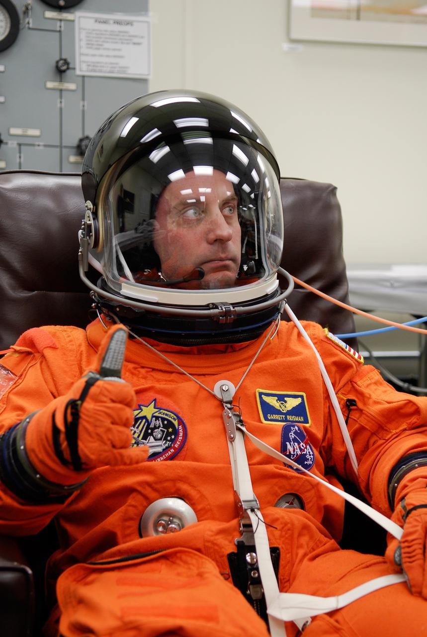KENNEDY SPACE CENTER, FLA. -- STS-123 Mission Specialist Garrett Reisman signals he is ready after suiting up for launch on space shuttle Endeavour. Reisman will remain on the International Space Station as a flight engineer. The crew will make a record-breaking 16-day mission to the International Space Station. On STS-123, Endeavour and its crew will deliver the first section of the Japan Aerospace Exploration Agency's Kibo laboratory and the Canadian Space Agency's two-armed robotic system, Dextre. Launch is scheduled for 2:28 a.m. EDT March 11. Photo credit: NASA/Kim Shiflett