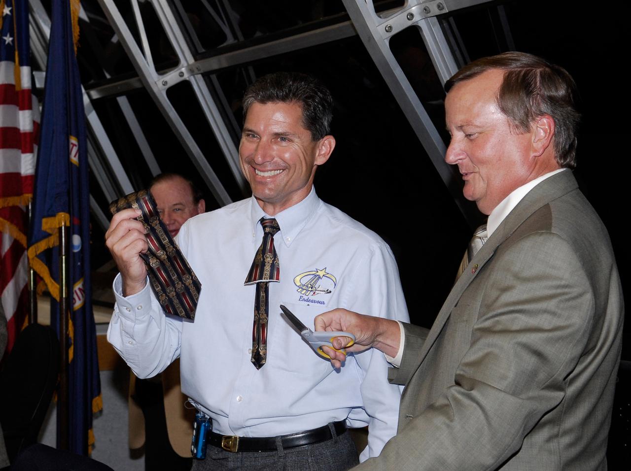 KENNEDY SPACE CENTER, FLA. --   NASA Flow Director for space shuttle Endeavour, Ken Tenbusch (left) holds the tie cut by Shuttle Launch Director Mike Leinbach (right) after the successful launch of Endeavour.  The tie-cutting is a tradition for first-timers.  Liftoff was on time at 2:28 a.m. EDT.  The crew will make a record-breaking 16-day mission to the International Space Station and deliver the first section of the Japan Aerospace Exploration Agency's Kibo laboratory and the Canadian Space Agency's two-armed robotic system, Dextre.  Photo credit: NASA/Kim Shiflett