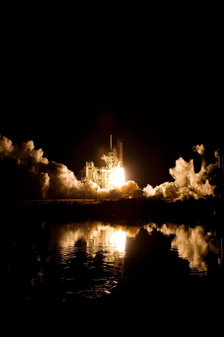 KENNEDY SPACE CENTER, FLA. --  Clouds of smoke and steam capture light from the fiery columns beneath space shuttle Endeavour as it lifts off on the STS-123 mission.  Liftoff was on time at 2:28 a.m. EDT.  The crew will make a record-breaking 16-day mission to the International Space Station and deliver the first section of the Japan Aerospace Exploration Agency's Kibo laboratory and the Canadian Space Agency's two-armed robotic system, Dextre.  Photo credit: NASA/Sandra Joseph, Tony Gray, Robert Murray