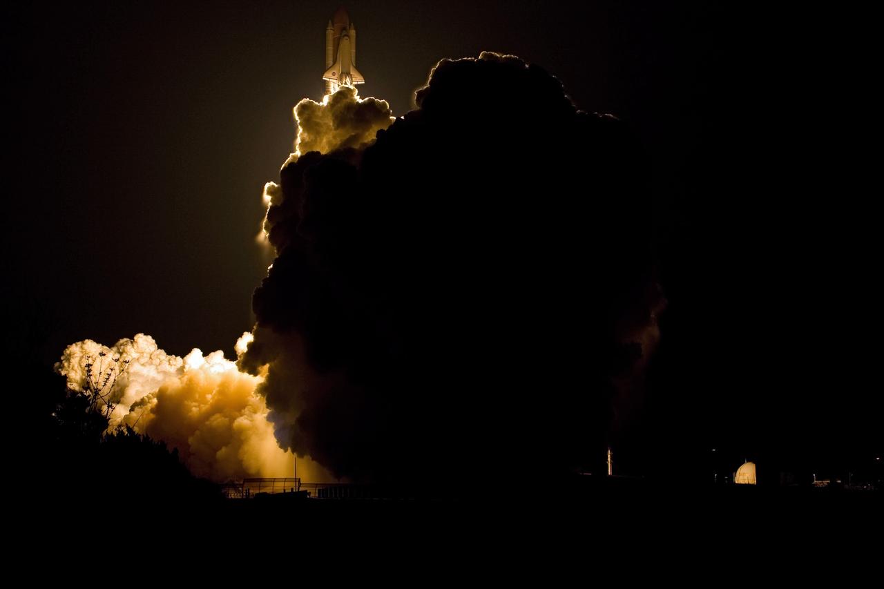 KENNEDY SPACE CENTER, FLA. -- Space shuttle Endeavour hurtles above the clouds of smoke and steam billowing across Launch Pad 39A as it races into the night sky on the STS-123 mission.  Liftoff was on time at 2:28 a.m. EDT.  The crew will make a record-breaking 16-day mission to the International Space Station and deliver the first section of the Japan Aerospace Exploration Agency's Kibo laboratory and the Canadian Space Agency's two-armed robotic system, Dextre.  Photo credit: NASA/Sandra Joseph, Tony Gray, Robert Murray