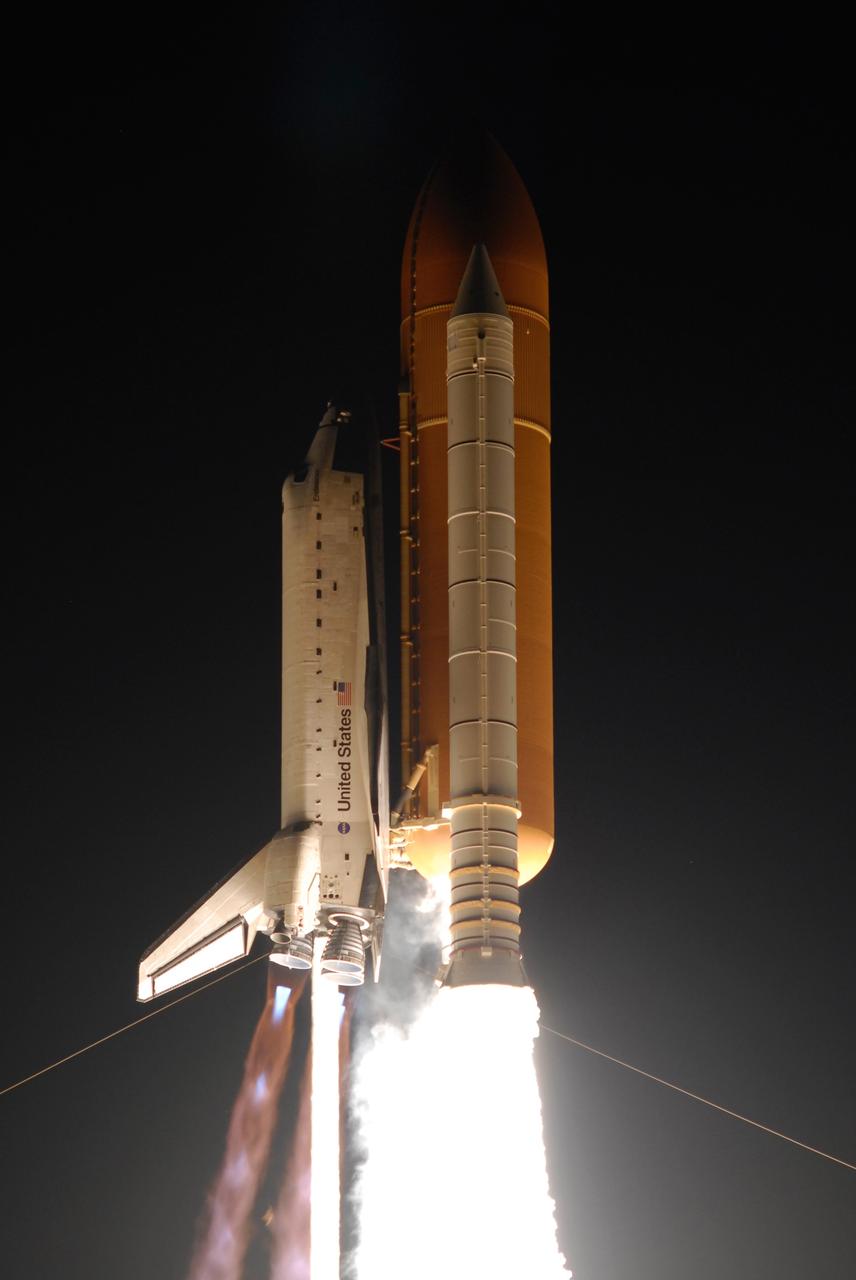 KENNEDY SPACE CENTER, FLA. --Racing into the night sky atop columns of fire, space shuttle Endeavour on mission STS-123 shows blue cones of light beneath its engines. The shock or mach diamonds are a formation of shock waves in the exhaust plume of an aerospace propulsion system.  Liftoff was on time at 2:28 a.m. EDT.  The crew will make a record-breaking 16-day mission to the International Space Station and deliver the first section of the Japan Aerospace Exploration Agency's Kibo laboratory and the Canadian Space Agency's two-armed robotic system, Dextre.  Photo credit: NASA/Jerry Cannon, Rusty Backer