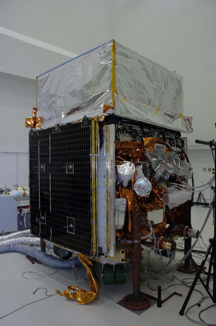 KENNEDY SPACE CENTER, FLA. -  In the Astrotech payload processing facility, one of twin solar arrays is positioned on NASA's Gamma-Ray Large Area Space Telescope, or GLAST.    The telescope will launch aboard a Delta II rocket May 16 from Launch Pad 17-B on Cape Canaveral Air Force Station. A powerful space observatory, the GLAST will explore the most extreme environments in the universe, and answer questions about supermassive black hole systems, pulsars and the origin of cosmic rays. It also will study the mystery of powerful explosions known as gamma-ray bursts. Photo credit: NASA/Chris Rhodes