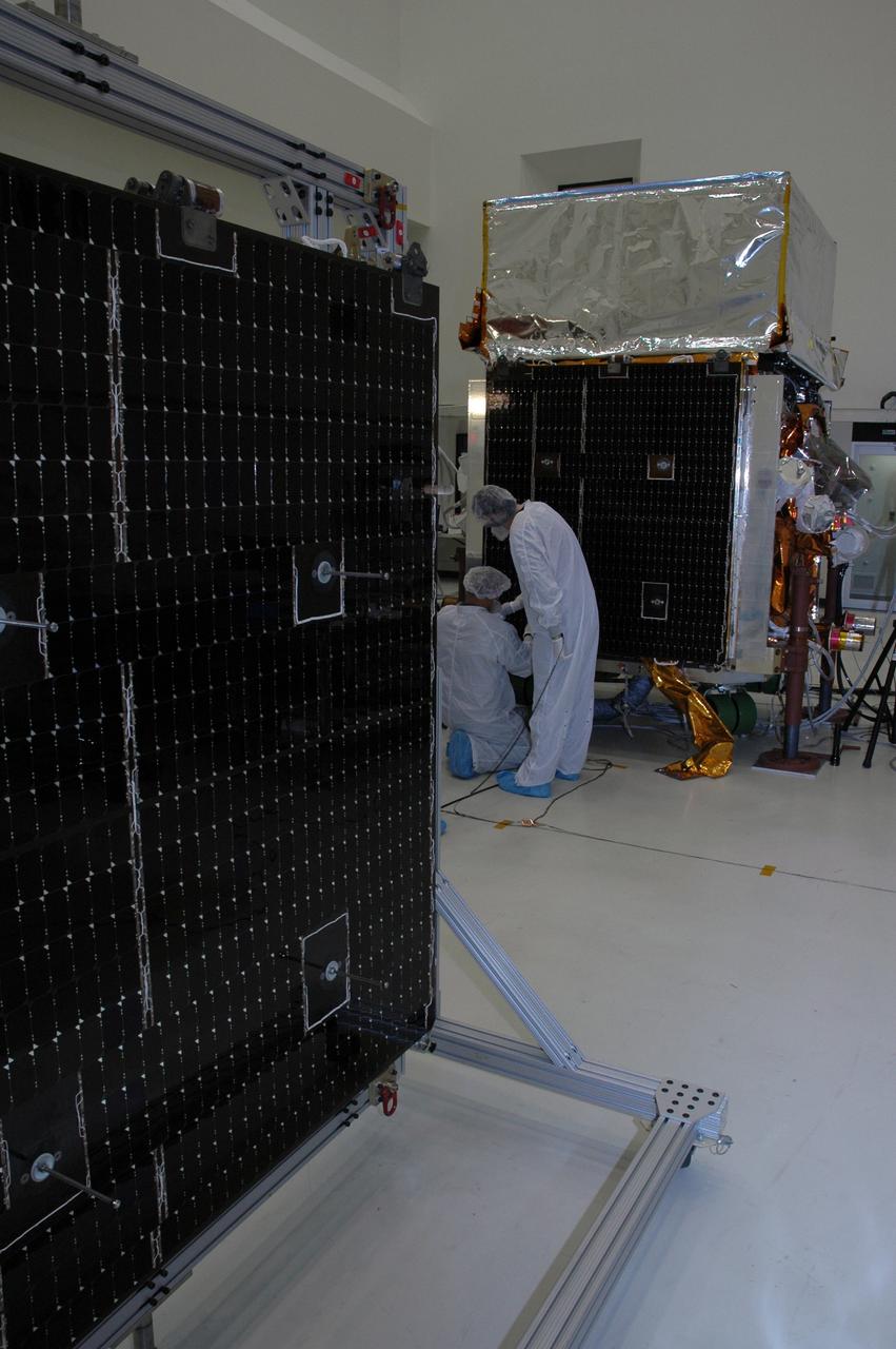 KENNEDY SPACE CENTER, FLA. - In the Astrotech payload processing facility, one of twin solar arrays awaits processing as General Dynamics technicians install the other of the pair on NASA's Gamma-Ray Large Area Space Telescope, or GLAST. The telescope will launch aboard a Delta II rocket May 16 from Launch Pad 17-B on Cape Canaveral Air Force Station. A powerful space observatory, the GLAST will explore the most extreme environments in the universe, and answer questions about supermassive black hole systems, pulsars and the origin of cosmic rays. It also will study the mystery of powerful explosions known as gamma-ray bursts. Photo credit: NASA/Chris Rhodes