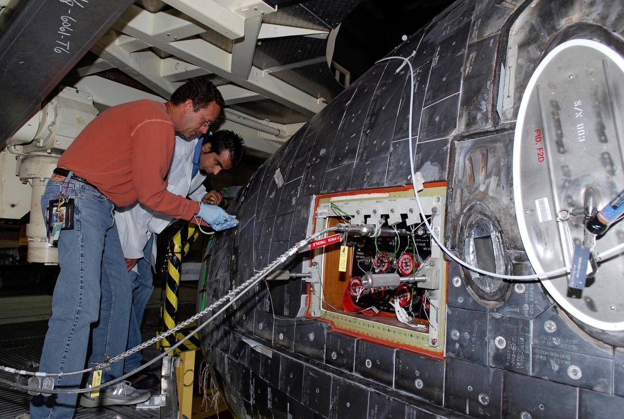 CAPE CANAVERAL, Fla. --- In the Orbiter Processing Facility at NASA's Kennedy Space Center, United Space Alliance technicians work on the thermal protection system tiles on space shuttle Discovery. The launch of Discovery on its STS-124 mission is targeted for April 24. On the mission, Discovery will transport the Kibo Japanese Experiment Module - Pressurized Module and the Japanese Remote Manipulator System to the International Space Station. Photo credit: NASA/Kim Shiflett