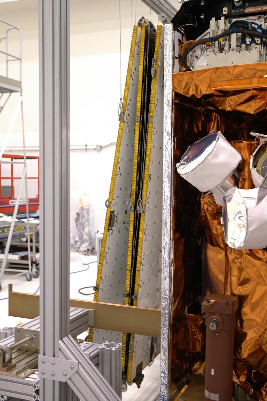 CAPE CANAVERAL, Fla. ---  In the Astrotech payload processing facility, the mechanism on NASA's Gamma-Ray Large Area Space Telescope, or GLAST, solar arrays has been released.  The telescope will launch aboard a Delta II rocket May 16 from Launch Pad 17-B on Cape Canaveral Air Force Station. A powerful space observatory, the GLAST will explore the most extreme environments in the universe, and answer questions about supermassive black hole systems, pulsars and the origin of cosmic rays. It also will study the mystery of powerful explosions known as gamma-ray bursts.  Photo credit: NASA/Jim Grossmann