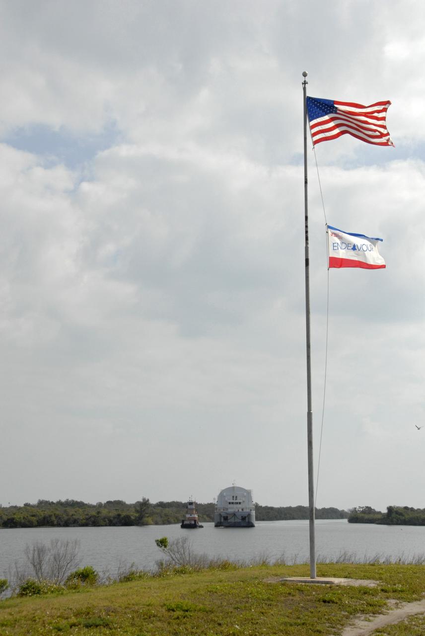 CAPE CANAVERAL, Fla. --- A tugboat tows the Pegasus barge through the turn basin in the Launch Complex 39 Area at NASA's Kennedy Space Center. The flag at right signifies that space shuttle Endeavour is still on orbit on the STS-123 mission. The barge is carrying external tank No. 128 for space shuttle Discovery's STS-124 mission. After offloading, the tank will be transported to the Vehicle Assembly Building. On the STS-124 mission, Discovery will transport the Kibo Japanese Experiment Module - Pressurized Module and the Japanese Remote Manipulator System to the International Space Station. Discovery is targeted for launch on May 25. Photo credit: NASA/Dimitri Gerondidakis