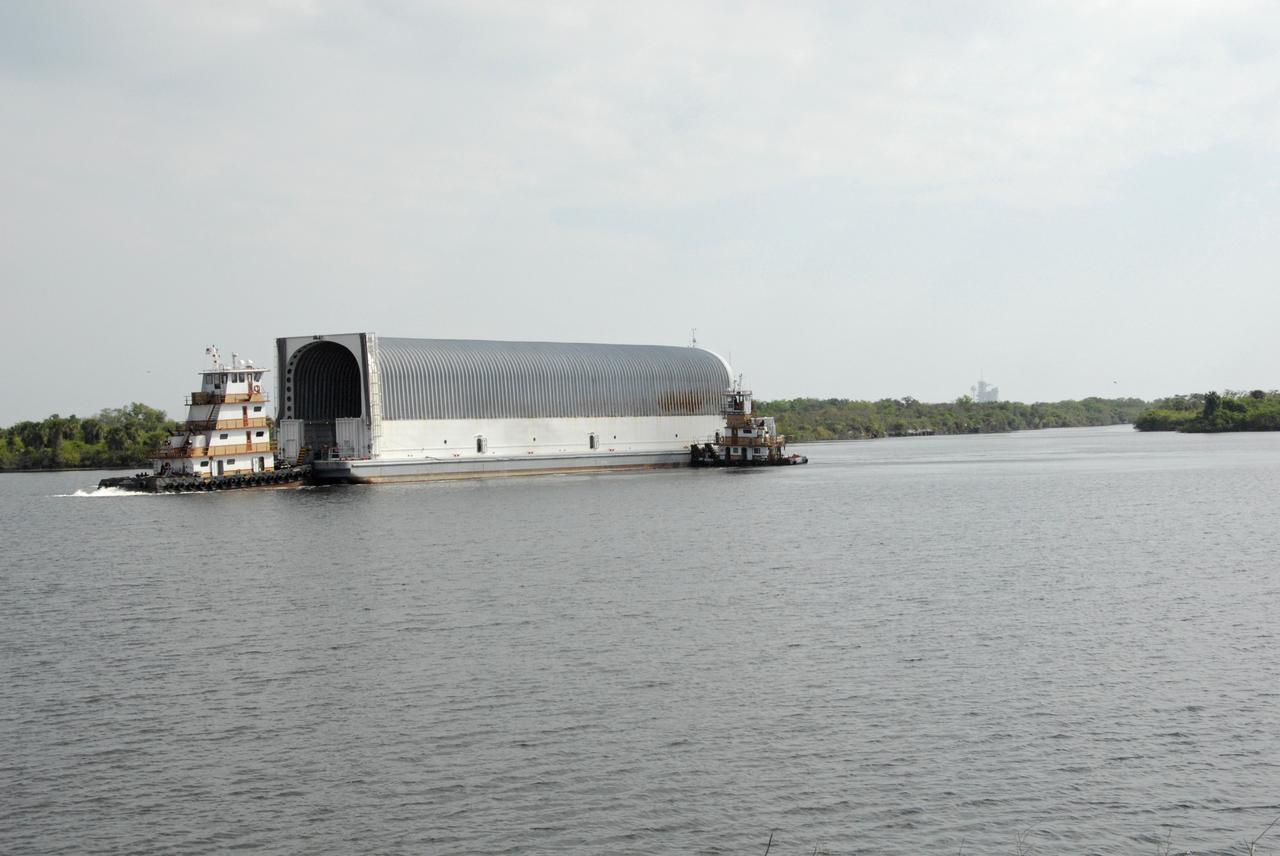 CAPE CANAVERAL, Fla. --- Two tugboats maneuver the Pegasus barge toward the dock in the turn basin in the Launch Complex 39 Area at NASA's Kennedy Space Center. The barge is carrying external tank No. 128 for space shuttle Discovery's STS-124 mission. After offloading, the tank will be transported to the Vehicle Assembly Building. On the STS-124 mission, Discovery will transport the Kibo Japanese Experiment Module - Pressurized Module and the Japanese Remote Manipulator System to the International Space Station. Discovery is targeted for launch on May 25. Photo credit: NASA/Dimitri Gerondidakis