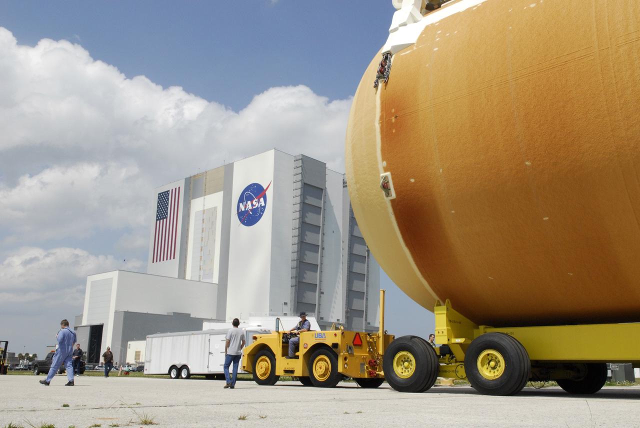 CAPE CANAVERAL, Fla. ---  After offloading external tank No. 128 from the Pegasus barge in the Launch Complex 39 Area at NASA's Kennedy Space Center, the tow vehicle begins moving it to the Vehicle Assembly Building, in the background. The tank is scheduled for space shuttle Discovery's STS-124 mission.  On the STS-124 mission, Discovery will transport the Kibo Japanese Experiment Module - Pressurized Module and the Japanese Remote Manipulator System to the International Space Station. Discovery is targeted for launch on May 25.  Photo credit: NASA/Dimitri Gerondidakis