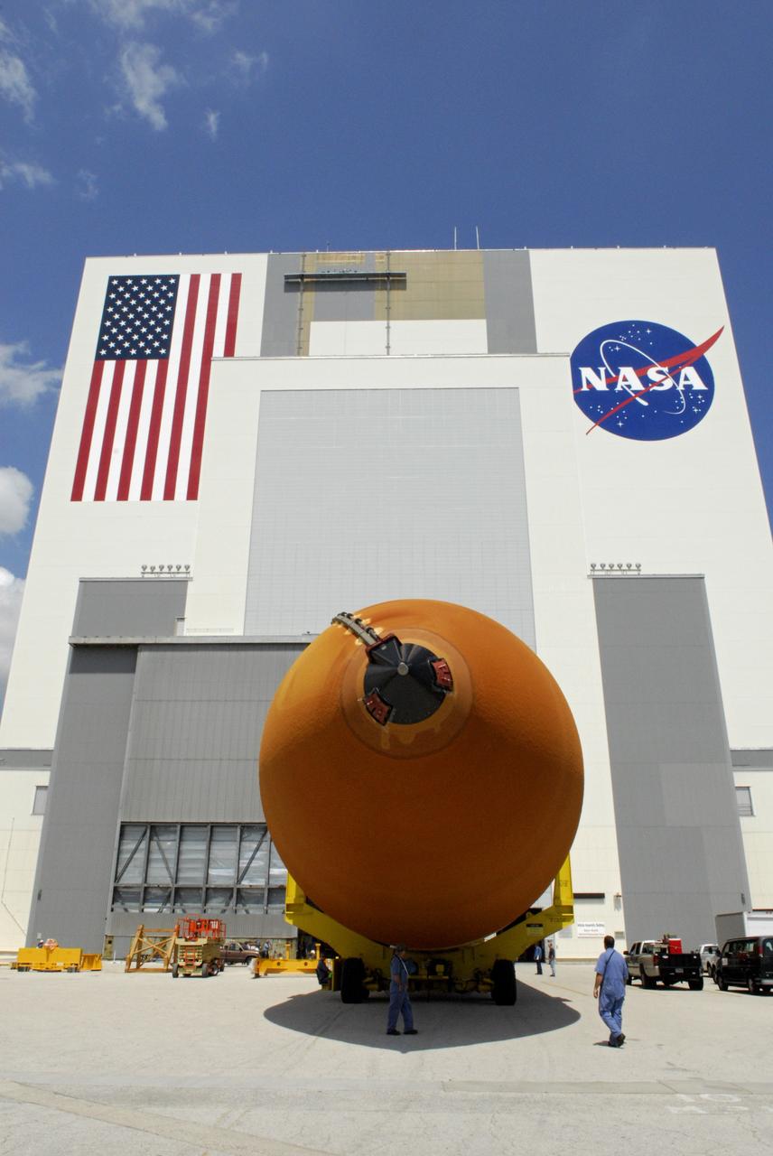 CAPE CANAVERAL, Fla. --- External tank No. 128 is towed toward the Vehicle Assembly Building, behind it. Once inside the building, the tank will be raised to vertical, lifted and moved into a checkout cell. The tank is scheduled for space shuttle Discovery's STS-124 mission. On the STS-124 mission, Discovery will transport the Kibo Japanese Experiment Module - Pressurized Module and the Japanese Remote Manipulator System to the International Space Station. Discovery is targeted for launch on May 25. Photo credit: NASA/Dimitri Gerondidakis