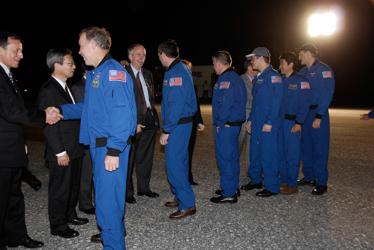 CAPE CANAVERAL, Fla. --- The STS-123 crewmembers are greeted by NASA VIPs and guests at NASA Kennedy Space Center's Shuttle Landing Facility.  From left in the blue flight suits are Commander Dominic Gorie, Mission Specialist Mike Foreman, Pilot Gregory H. Johnson, and Mission Specialists Robert L. Behnken, Takao Doi of the Japan Aerospace Exploration Agency, and Rick Linnehan.  Space shuttle Endeavour landed on Runway 15 at NASA Kennedy Space Center's Shuttle Landing Facility to end the STS-123 mission, a 16-day flight to the International Space Station.  This was the 16th night landing at Kennedy.  The main landing gear touched down at 8:39:08 p.m. EDT.  The nose landing gear touched down at 8:39:17 p.m. and wheel stop was at 8:40:41 p.m.  The mission completed nearly 6.6 million miles.  The landing was on the second opportunity after the first was waved off due to unstable weather in the Kennedy Space Center area.  The STS-123 mission delivered the first segment of the Japan Aerospace Exploration Agency's Kibo laboratory and the Canadian Space Agency's two-armed robotic system, known as Dextre.  Photo credit: NASA/Kim Shiflett