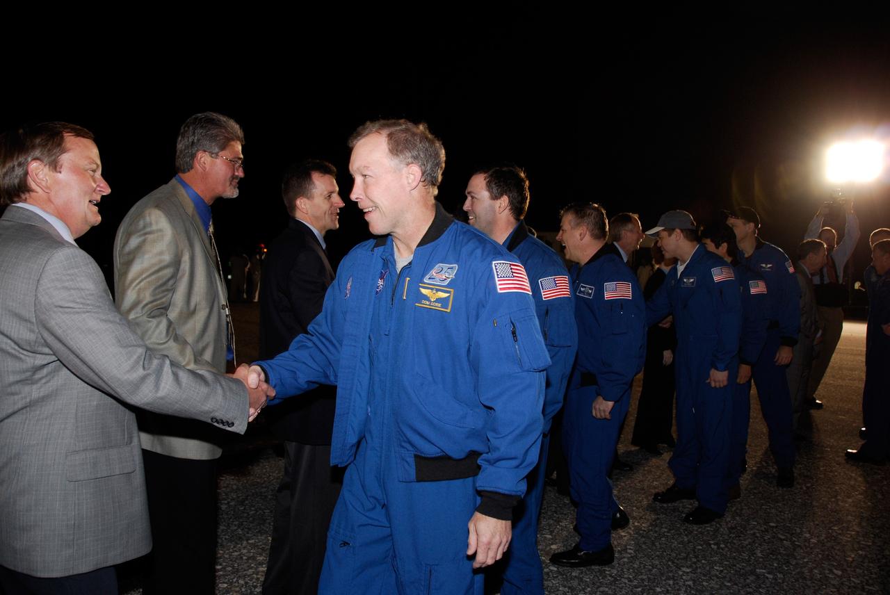CAPE CANAVERAL, Fla. --- The STS-123 crewmembers are greeted by NASA VIPs and guests at NASA Kennedy Space Center's Shuttle Landing Facility.  From left, in the blue flight suits, are Commander Dominic Gorie, Mission Specialist Mike Foreman, Pilot Gregory H. Johnson, and Mission Specialists Robert L. Behnken, Takao Doi of the Japan Aerospace Exploration Agency, and Rick Linnehan.  From left, the NASA managers in the back row are Space Shuttle Launch Director Mike Leinbach, Kennedy Space Center Director Bill Parsons, and Chairman of Mission Management Team LeRoy Cain.  Space shuttle Endeavour landed on Runway 15 at NASA Kennedy Space Center's Shuttle Landing Facility to end the STS-123 mission, a 16-day flight to the International Space Station.  This was the 16th night landing at Kennedy.  The main landing gear touched down at 8:39:08 p.m. EDT.  The nose landing gear touched down at 8:39:17 p.m. and wheel stop was at 8:40:41 p.m.  The mission completed nearly 6.6 million miles.  The landing was on the second opportunity after the first was waved off due to unstable weather in the Kennedy Space Center area.   The STS-123 mission delivered the first segment of the Japan Aerospace Exploration Agency's Kibo laboratory and the Canadian Space Agency's two-armed robotic system, known as Dextre.  Photo credit: NASA/Kim Shiflett