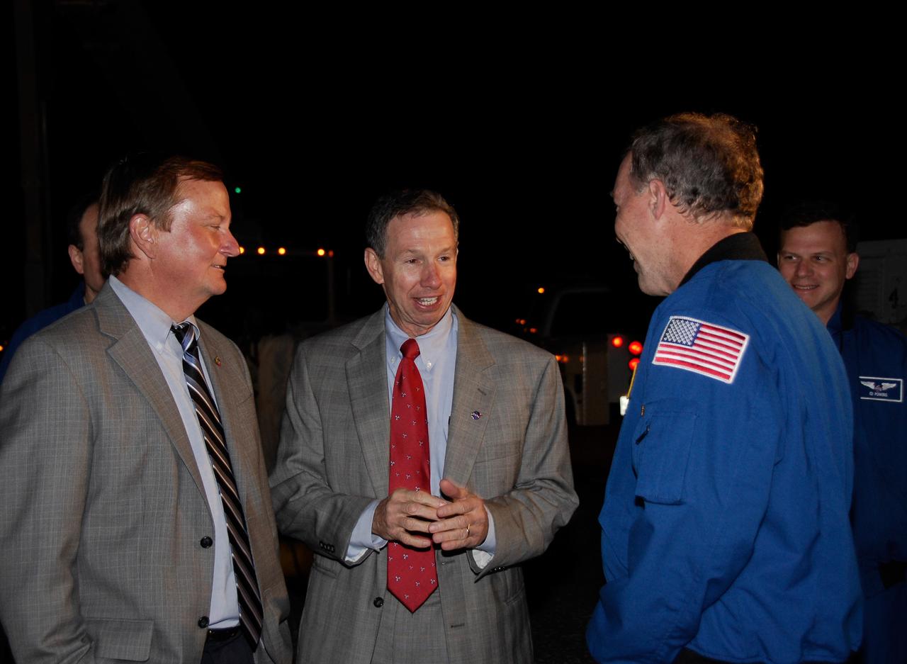 CAPE CANAVERAL, Fla. --- STS-123 Commander Dominic Gorie, right, is greeted by Space Shuttle Launch Director Mike Leinbach, left, and NASA Administrator Mike Griffin at NASA Kennedy Space Center's Shuttle Landing Facility.  Space shuttle Endeavour landed on Runway 15 to end the STS-123 mission, a 16-day flight to the International Space Station.  This was the 16th night landing at Kennedy.  The main landing gear touched down at 8:39:08 p.m. EDT.  The nose landing gear touched down at 8:39:17 p.m. and wheel stop was at 8:40:41 p.m.  The mission completed nearly 6.6 million miles.  The landing was on the second opportunity after the first was waved off due to unstable weather in the Kennedy Space Center area.   The STS-123 mission delivered the first segment of the Japan Aerospace Exploration Agency's Kibo laboratory and the Canadian Space Agency's two-armed robotic system, known as Dextre.  Photo credit: NASA/Kim Shiflett
