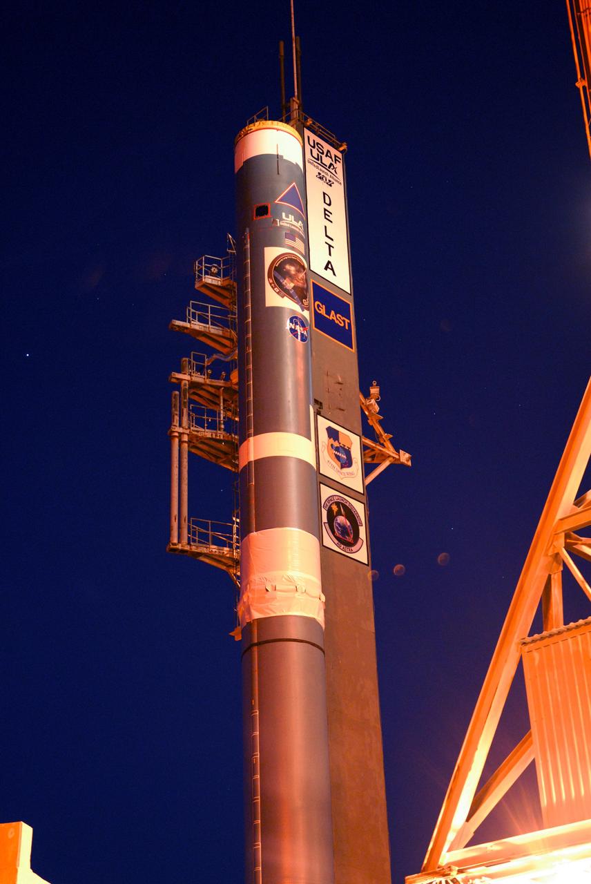 CAPE CANAVERAL, Fla. ---   At Cape Canaveral Air Force Station, the Delta II rocket to launch NASA's Gamma-ray Large Area Space Telescope, or GLAST, spacecraft is poised to receive the first of the solid rocket boosters.  A series of nine strap-on solid rocket motors will help power the first stage.  The GLAST is a powerful space observatory that will explore the Universe's ultimate frontier, where nature harnesses forces and energies far beyond anything possible on Earth;  probe some of science's deepest questions, such as what our Universe is made of, and search for new laws of physics; explain how black holes accelerate jets of material to nearly light speed; and help crack the mystery of stupendously powerful explosions known as gamma-ray bursts.  Launch is currently planned for May 16 from Pad 17-B.   Photo credit: NASA/Dimitri Gerondidakis