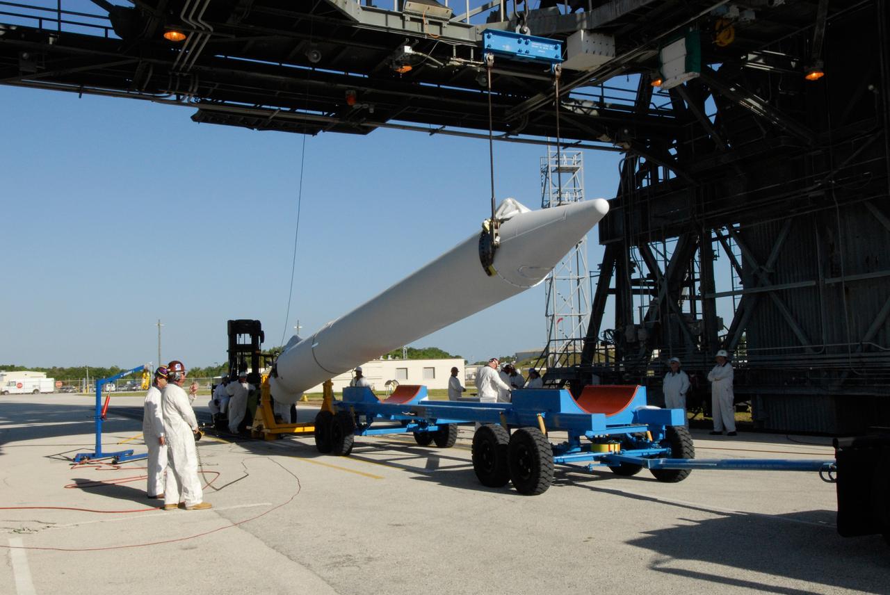 CAPE CANAVERAL, Fla. ---  At Pad 17-B on Cape Canaveral Air Force Station, a solid rocket booster is raised from its transporter.  The booster will be lifted into the mobile service tower for mating with the Delta II rocket to launch NASA's Gamma-ray Large Area Space Telescope, or GLAST, spacecraft.  A series of nine strap-on solid rocket motors will help power the first stage.  The GLAST is a powerful space observatory that will explore the Universe's ultimate frontier, where nature harnesses forces and energies far beyond anything possible on Earth;  probe some of science's deepest questions, such as what our Universe is made of, and search for new laws of physics; explain how black holes accelerate jets of material to nearly light speed; and help crack the mystery of stupendously powerful explosions known as gamma-ray bursts.  Launch is currently planned for May 16 from Pad 17-B.   Photo credit: NASA/Dimitri Gerondidakis