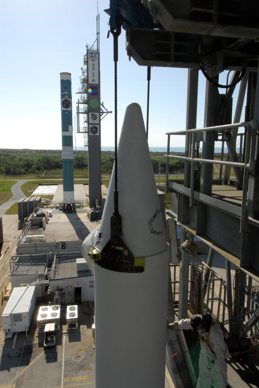 CAPE CANAVERAL, Fla. ---  At Pad 17-B on Cape Canaveral Air Force Station, a solid rocket booster is lifted into the mobile service tower for mating with the Delta II rocket to launch NASA's Gamma-ray Large Area Space Telescope, or GLAST, spacecraft.  A series of nine strap-on solid rocket motors will help power the first stage.  The GLAST is a powerful space observatory that will explore the Universe's ultimate frontier, where nature harnesses forces and energies far beyond anything possible on Earth;  probe some of science's deepest questions, such as what our Universe is made of, and search for new laws of physics; explain how black holes accelerate jets of material to nearly light speed; and help crack the mystery of stupendously powerful explosions known as gamma-ray bursts.  Launch is currently planned for May 16 from Pad 17-B.   Photo credit: NASA/Dimitri Gerondidakis