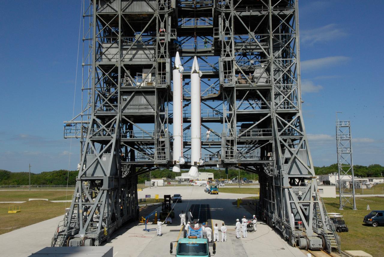 CAPE CANAVERAL, Fla. ---  At Pad 17-B on Cape Canaveral Air Force Station, a second solid rocket booster joins the first booster lifted into the mobile service tower for mating with the Delta II rocket that will launch NASA's Gamma-ray Large Area Space Telescope, or GLAST, spacecraft.  A series of nine strap-on solid rocket motors will help power the first stage. The GLAST is a powerful space observatory that will explore the Universe's ultimate frontier, where nature harnesses forces and energies far beyond anything possible on Earth;  probe some of science's deepest questions, such as what our Universe is made of, and search for new laws of physics; explain how black holes accelerate jets of material to nearly light speed; and help crack the mystery of stupendously powerful explosions known as gamma-ray bursts.  Launch is currently planned for May 16 from Pad 17-B.   Photo credit: NASA/Dimitri Gerondidakis
