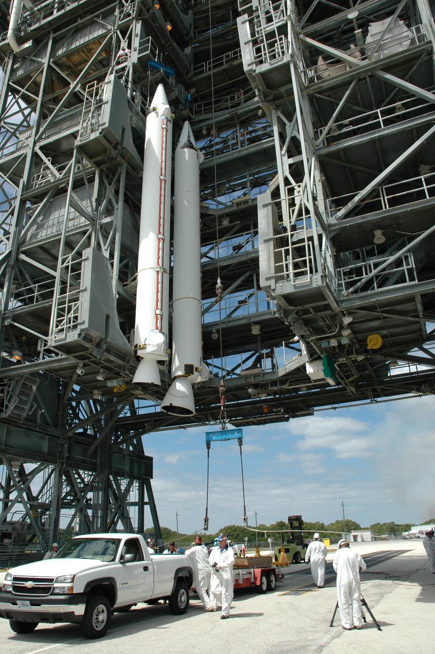 CAPE CANAVERAL, Fla. ---  At Pad 17-B on Cape Canaveral Air Force Station, a second solid rocket booster joins the first booster lifted into the mobile service tower for mating with the Delta II rocket that will launch NASA's Gamma-ray Large Area Space Telescope, or GLAST, spacecraft.  A series of nine strap-on solid rocket motors will help power the first stage.  Because the Delta rocket is configured as a Delta II 7920 Heavy, the boosters are larger than those used on the standard configuration.  The GLAST is a powerful space observatory that will explore the Universe's ultimate frontier, where nature harnesses forces and energies far beyond anything possible on Earth;  probe some of science's deepest questions, such as what our Universe is made of, and search for new laws of physics; explain how black holes accelerate jets of material to nearly light speed; and help crack the mystery of stupendously powerful explosions known as gamma-ray bursts.  Launch is currently planned for May 16 from Pad 17-B.   Photo credit: NASA/Jim Grossmann