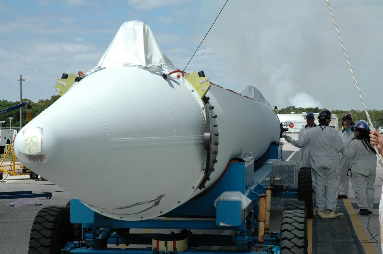 CAPE CANAVERAL, Fla. ---   A third solid rocket booster arrives on Pad 17-B on Cape Canaveral Air Force Station for mating with the Delta II rocket that will launch NASA's Gamma-ray Large Area Space Telescope, or GLAST, spacecraft.  A series of nine strap-on solid rocket motors will help power the first stage.  Because the Delta rocket is configured as a Delta II 7920 Heavy, the boosters are larger than those used on the standard configuration.  The GLAST is a powerful space observatory that will explore the Universe's ultimate frontier, where nature harnesses forces and energies far beyond anything possible on Earth;  probe some of science's deepest questions, such as what our Universe is made of, and search for new laws of physics; explain how black holes accelerate jets of material to nearly light speed; and help crack the mystery of stupendously powerful explosions known as gamma-ray bursts.  Launch is currently planned for May 16 from Pad 17-B.   Photo credit: NASA/Jim Grossmann