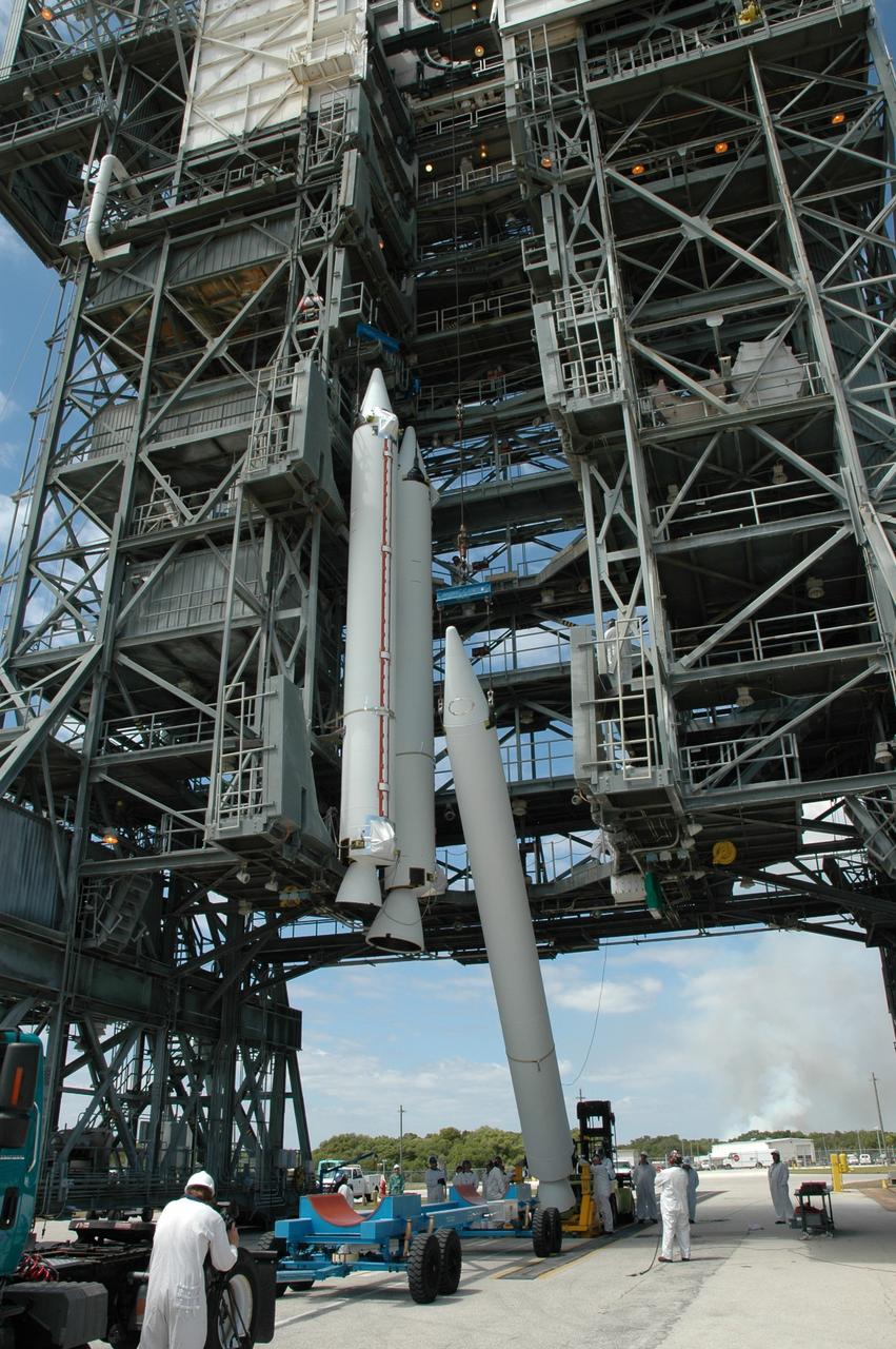 CAPE CANAVERAL, Fla. ---  On Pad 17-B on Cape Canaveral Air Force Station, the solid rocket booster is raised from its transporter toward a vertical position. When it has been raised, the booster will be lifted into the mobile service tower for mating with the Delta II rocket that will launch NASA's Gamma-ray Large Area Space Telescope, or GLAST, spacecraft.  Two other boosters are already in place.  A series of nine strap-on solid rocket motors will help power the first stage.  Because the Delta rocket is configured as a Delta II 7920 Heavy, the boosters are larger than those used on the standard configuration.  The GLAST is a powerful space observatory that will explore the Universe's ultimate frontier, where nature harnesses forces and energies far beyond anything possible on Earth;  probe some of science's deepest questions, such as what our Universe is made of, and search for new laws of physics; explain how black holes accelerate jets of material to nearly light speed; and help crack the mystery of stupendously powerful explosions known as gamma-ray bursts.  Launch is currently planned for May 16 from Pad 17-B.   Photo credit: NASA/Jim Grossmann