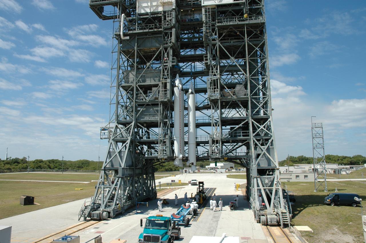 CAPE CANAVERAL, Fla. ---  On Pad 17-B on Cape Canaveral Air Force Station, the third solid rocket booster joins two others in the mobile service tower.  They will be mated with the Delta II rocket that will launch NASA's Gamma-ray Large Area Space Telescope, or GLAST, spacecraft. A series of nine strap-on solid rocket motors will help power the first stage.  Because the Delta rocket is configured as a Delta II 7920 Heavy, the boosters are larger than those used on the standard configuration.  The GLAST is a powerful space observatory that will explore the Universe's ultimate frontier, where nature harnesses forces and energies far beyond anything possible on Earth;  probe some of science's deepest questions, such as what our Universe is made of, and search for new laws of physics; explain how black holes accelerate jets of material to nearly light speed; and help crack the mystery of stupendously powerful explosions known as gamma-ray bursts.  Launch is currently planned for May 16 from Pad 17-B.   Photo credit: NASA/Jim Grossmann