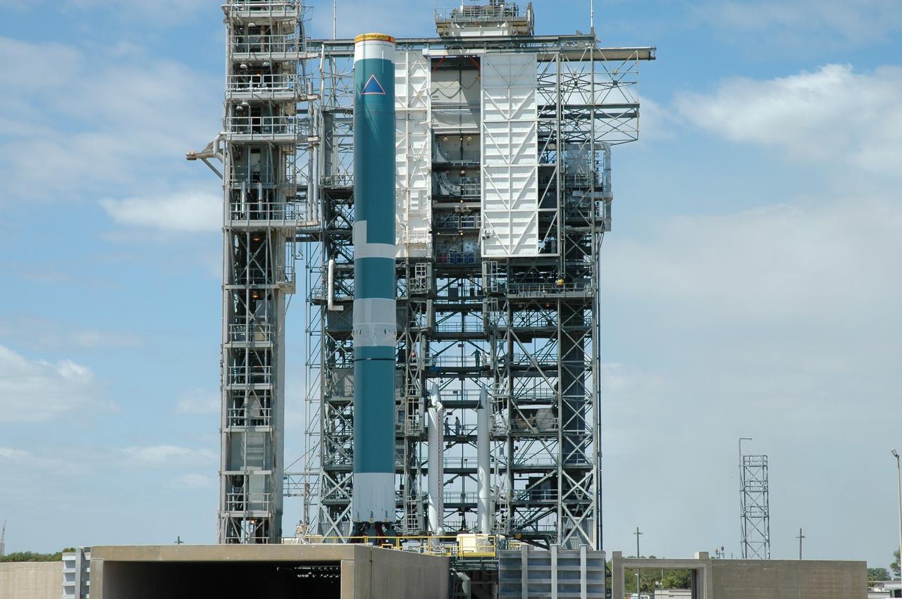 CAPE CANAVERAL, Fla. ---  On Pad 17-B on Cape Canaveral Air Force Station, three solid rocket boosters are in the mobile service tower.  They will be mated with the Delta II rocket, at left, that will launch NASA's Gamma-ray Large Area Space Telescope, or GLAST, spacecraft. A series of nine strap-on solid rocket motors will help power the first stage.  Because the Delta rocket is configured as a Delta II 7920 Heavy, the boosters are larger than those used on the standard configuration.  The GLAST is a powerful space observatory that will explore the Universe's ultimate frontier, where nature harnesses forces and energies far beyond anything possible on Earth;  probe some of science's deepest questions, such as what our Universe is made of, and search for new laws of physics; explain how black holes accelerate jets of material to nearly light speed; and help crack the mystery of stupendously powerful explosions known as gamma-ray bursts.  Launch is currently planned for May 16 from Pad 17-B.   Photo credit: NASA/Jim Grossmann