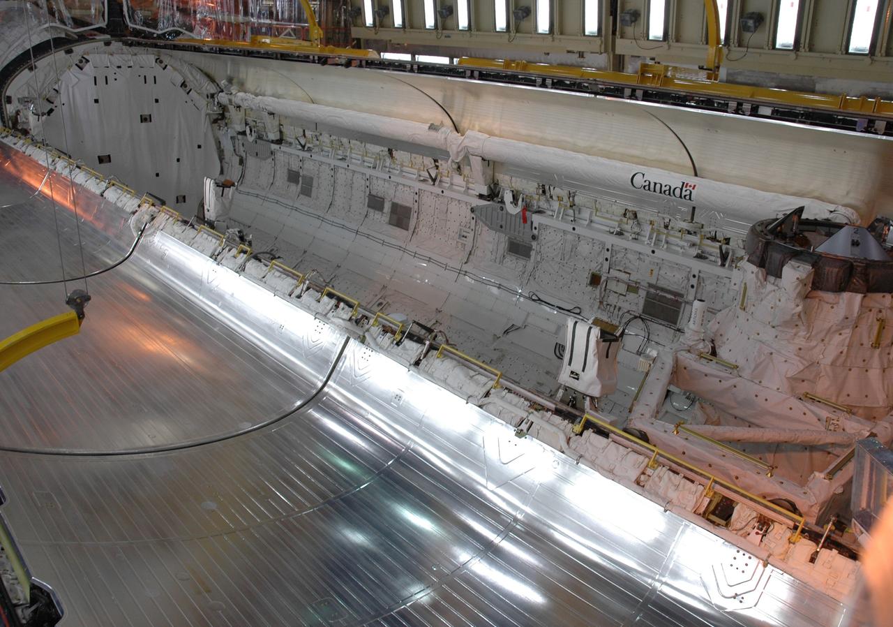 CAPE CANAVERAL, Fla. --- In Orbiter Processing Facility Bay 3 at NASA's Kennedy Space Center, space shuttle Discovery's payload bay door at right is nearly closed. Below the door is the shuttle's robotic arm. Discovery is the designated vehicle on the STS-124 mission to the International Space Station. On the mission, the shuttle will transport the Kibo Japanese Experiment Module - Pressurized Module and the Japanese Remote Manipulator System. The payload will be installed at the launch pad. Launch is targeted for May 25. Photo credit: NASA/Chris Rhodes