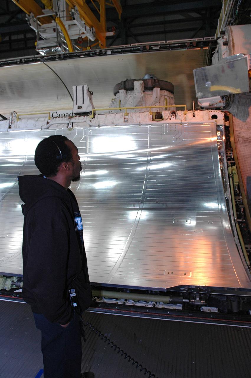 CAPE CANAVERAL, Fla. ---  In Orbiter Processing Facility Bay 3 at NASA's Kennedy Space Center, a worker observes space shuttle Discovery's payload bay as the doors are closed.  Discovery is the designated vehicle on the STS-124 mission to the International Space Station.  On the mission, the shuttle will transport the Kibo Japanese Experiment Module - Pressurized Module and the Japanese Remote Manipulator System. The payload will be installed at the launch pad.  Launch is targeted for May 25.  Photo credit: NASA/Chris Rhodes