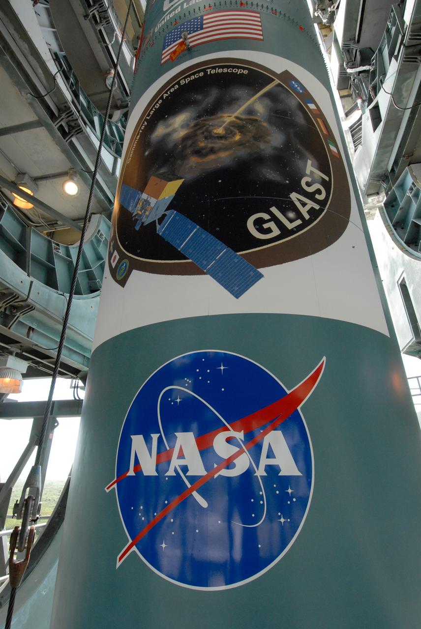 CAPE CANAVERAL, Fla. ---  On Pad 17-B at Cape Canaveral Air Force Station in Florida, the Delta II  rocket displays the NASA  logo and the mission patch for NASA's Gamma-ray Large Area Space Telescope, or GLAST.  The GLAST is a powerful space observatory that will explore the Universe's ultimate frontier, where nature harnesses forces and energies far beyond anything possible on Earth;  probe some of science's deepest questions, such as what our Universe is made of, and search for new laws of physics; explain how black holes accelerate jets of material to nearly light speed; and help crack the mystery of stupendously powerful explosions known as gamma-ray bursts.  Launch is currently planned in a window between 11:45 a.m. and 1:40 p.m. May 16.  Photo credit: NASA/Troy Cryder