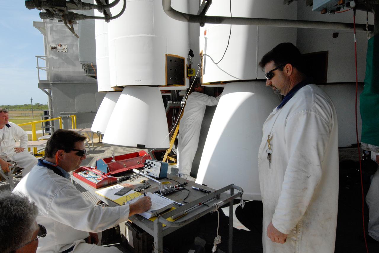 CAPE CANAVERAL, Fla. ---  On Pad 17-B at Cape Canaveral Air Force Station in Florida, United Launch Alliance technicians check the list of activities completed on the mating of the nine solid rocket boosters to the Delta II rocket for the launch of  NASA's Gamma-ray Large Area Space Telescope, or GLAST. The GLAST is a powerful space observatory that will explore the Universe's ultimate frontier, where nature harnesses forces and energies far beyond anything possible on Earth;  probe some of science's deepest questions, such as what our Universe is made of, and search for new laws of physics; explain how black holes accelerate jets of material to nearly light speed; and help crack the mystery of stupendously powerful explosions known as gamma-ray bursts.  Launch is currently planned in a window between 11:45 a.m. and 1:40 p.m. May 16.  Photo credit: NASA/Troy Cryder