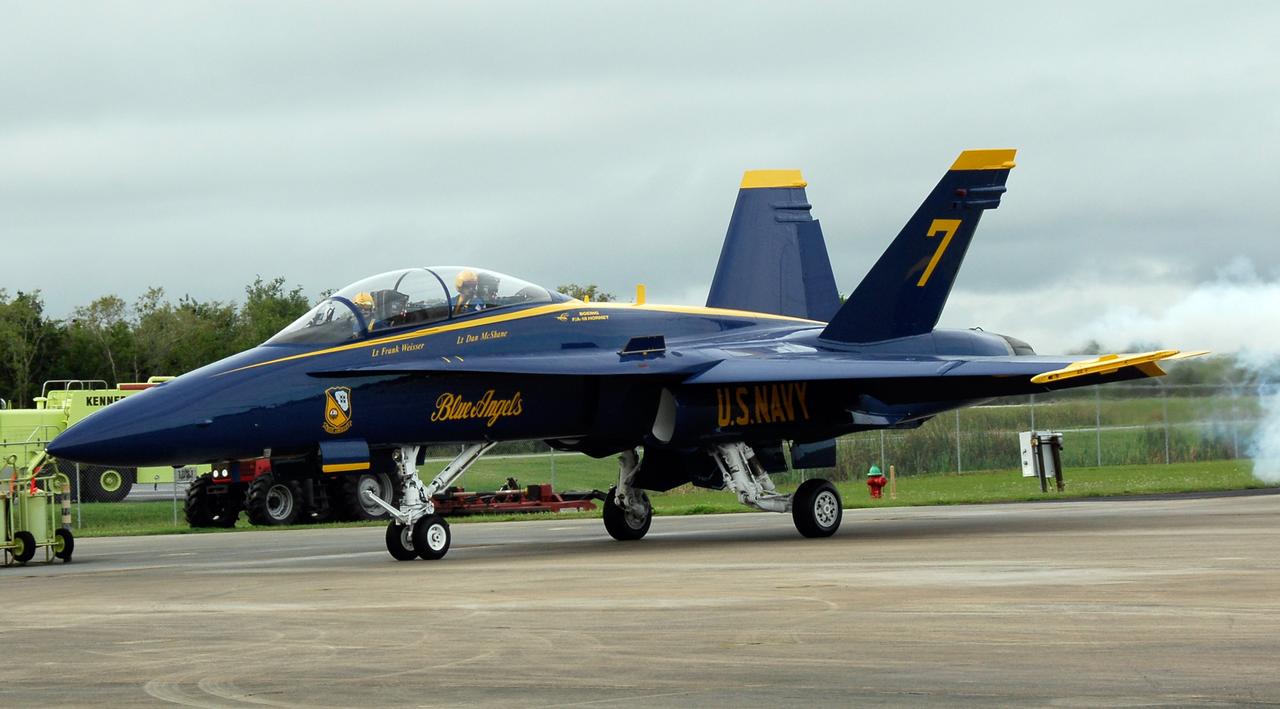 CAPE CANAVERAL, Fla. -- A U.S. Navy F-18 Hornet taxis on the Shuttle Landing Facility runway at NASA's Kennedy Space Center.  Aboard are Blue Angel pilots Lt. Frank Weisser and Lt. Dan McShane.  They flew into Kennedy to begin preparations for their involvement in the second annual Space & Air Show at Kennedy Space Center Nov. 8-9.  The air show will be only the second time the Blue Angels have performed at Kennedy.  Their precision flight team will perform high-speed passes, fast rolls, mirror formations, tight turns and their signature Delta formation showcasing the capabilities of the powerful aircraft.  The 2008 Space & Air Show will include aircraft displays and space-related exhibits on the ground and plenty of action in the skies over Kennedy.  Returning to the show is the 920th Rescue Wing, an Air Force Reserve Command combat search and rescue unit based at Patrick Air Force Base in Central Florida. Also, more than 20 astronauts and special guests will be on hand to personally meet guests, pose for photos and sign memorabilia.  Photo credit: NASA/Kim Shiflett
