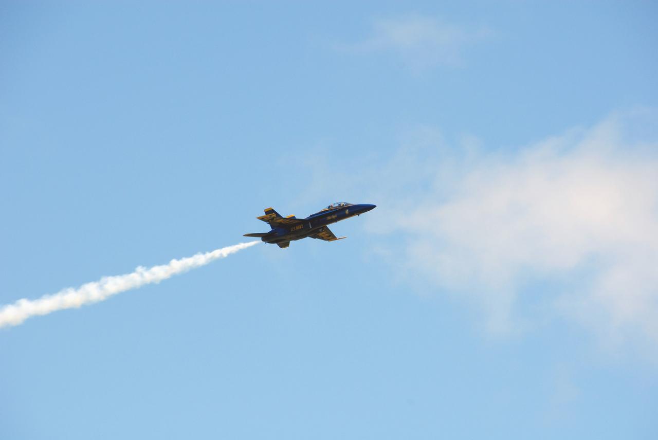 CAPE CANAVERAL, Fla. -- After meeting with NASA officials about their involvement in the second annual Space & Air Show at Kennedy Space Center Nov. 8-9, Blue Angel pilots Lt. Frank Weisser and Lt. Dan McShane take a last look at the center from their U.S. Navy F-18 Hornet as they return to their home base in Pensacola, Fla.   The air show will be only the second time the Blue Angels have performed at Kennedy.  Their precision flight team will perform high-speed passes, fast rolls, mirror formations, tight turns and their signature Delta formation showcasing the capabilities of the powerful aircraft.  The 2008 Space & Air Show will include aircraft displays and space-related exhibits on the ground and plenty of action in the skies over Kennedy.  Returning to the show is the 920th Rescue Wing, an Air Force Reserve Command combat search and rescue unit based at Patrick Air Force Base in Central Florida. Also, more than 20 astronauts and special guests will be on hand to personally meet guests, pose for photos and sign memorabilia.  Photo credit: NASA/Dimitri Gerondidakis