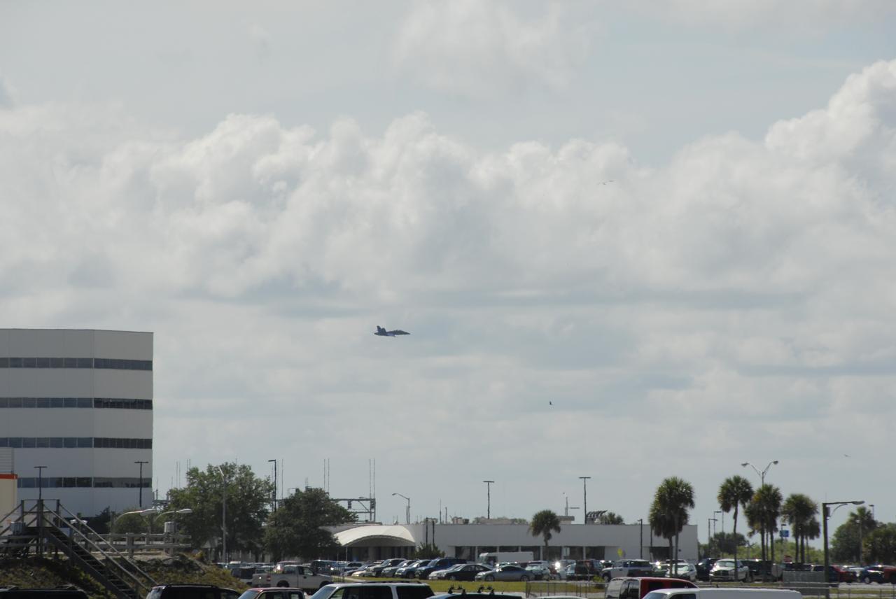 CAPE CANAVERAL, Fla. -- After meeting with NASA officials about their involvement in the second annual Space & Air Show at Kennedy Space Center Nov. 8-9, Blue Angel pilots Lt. Frank Weisser and Lt. Dan McShane fly over the Launch Complex 39 area in their U.S. Navy F-18 Hornet as they return to their home base in Pensacola, Fla.   The air show will be only the second time the Blue Angels have performed at Kennedy.  Their precision flight team will perform high-speed passes, fast rolls, mirror formations, tight turns and their signature Delta formation showcasing the capabilities of the powerful aircraft.  The 2008 Space & Air Show will include aircraft displays and space-related exhibits on the ground and plenty of action in the skies over Kennedy.  Returning to the show is the 920th Rescue Wing, an Air Force Reserve Command combat search and rescue unit based at Patrick Air Force Base in Central Florida. Also, more than 20 astronauts and special guests will be on hand to personally meet guests, pose for photos and sign memorabilia.  Photo credit: NASA/Dimitri Gerondidakis
