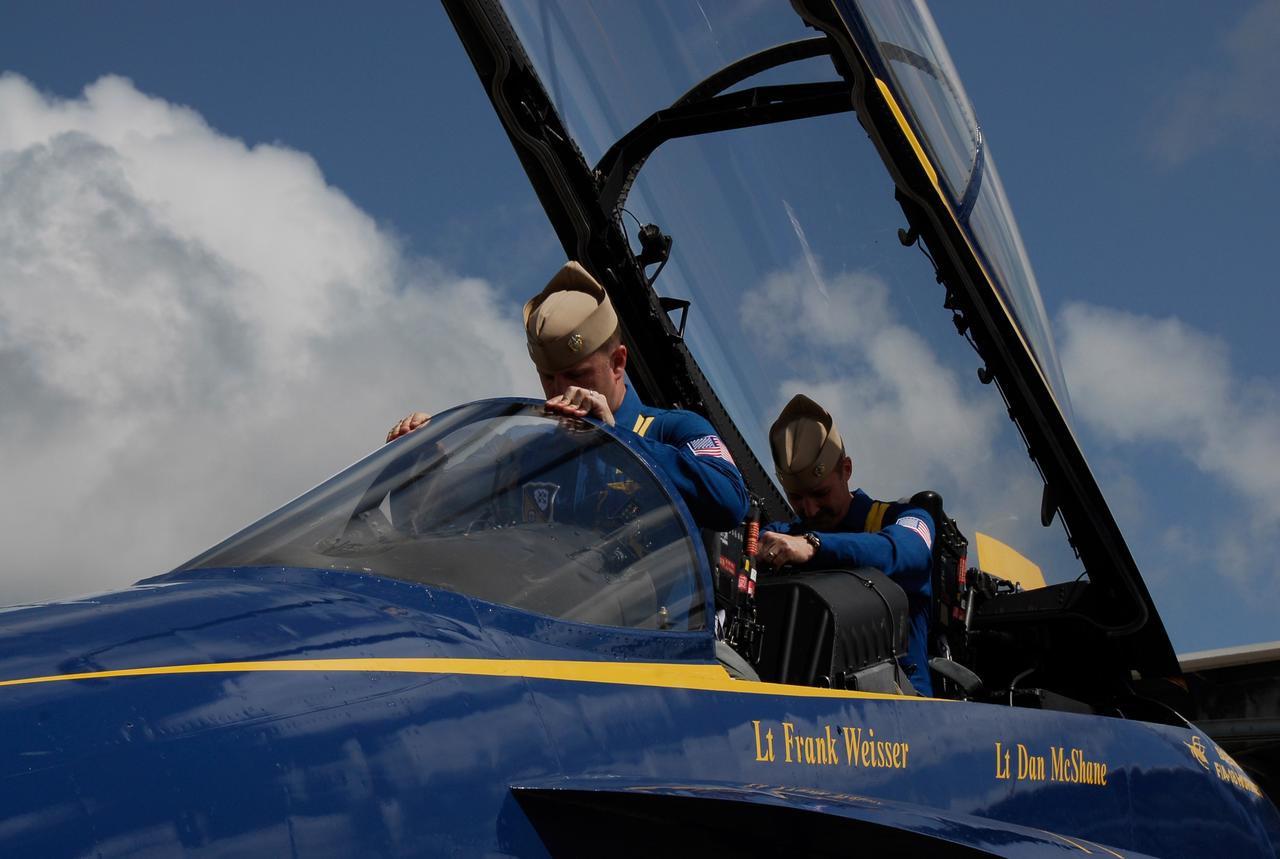 CAPE CANAVERAL, Fla. -- After meeting with NASA officials about their involvement in the second annual Space & Air Show at Kennedy Space Center Nov. 8-9, Blue Angel pilots Lt. Frank Weisser and Lt. Dan McShane board their U.S. Navy F-18 Hornet as they prepare to return to their home base in Pensacola, Fla.   The air show will be only the second time the Blue Angels have performed at Kennedy.  Their precision flight team will perform high-speed passes, fast rolls, mirror formations, tight turns and their signature Delta formation showcasing the capabilities of the powerful aircraft.  The 2008 Space & Air Show will include aircraft displays and space-related exhibits on the ground and plenty of action in the skies over Kennedy.  Returning to the show is the 920th Rescue Wing, an Air Force Reserve Command combat search and rescue unit based at Patrick Air Force Base in Central Florida. Also, more than 20 astronauts and special guests will be on hand to personally meet guests, pose for photos and sign memorabilia.  Photo credit: NASA/Kim Shiflett