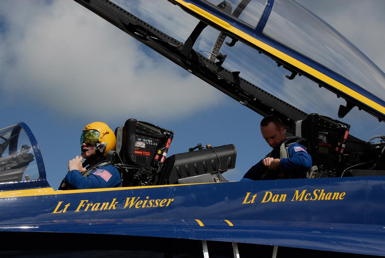CAPE CANAVERAL, Fla. -- After meeting with NASA officials about their involvement in the second annual Space & Air Show at Kennedy Space Center Nov. 8-9, Blue Angel pilots Lt. Frank Weisser and Lt. Dan McShane board their U.S. Navy F-18 Hornet as they prepare to return to their home base in Pensacola, Fla.    The air show will be only the second time the Blue Angels have performed at Kennedy.  Their precision flight team will perform high-speed passes, fast rolls, mirror formations, tight turns and their signature Delta formation showcasing the capabilities of the powerful aircraft.  The 2008 Space & Air Show will include aircraft displays and space-related exhibits on the ground and plenty of action in the skies over Kennedy.  Returning to the show is the 920th Rescue Wing, an Air Force Reserve Command combat search and rescue unit based at Patrick Air Force Base in Central Florida. Also, more than 20 astronauts and special guests will be on hand to personally meet guests, pose for photos and sign memorabilia.  Photo credit: NASA/Kim Shiflett