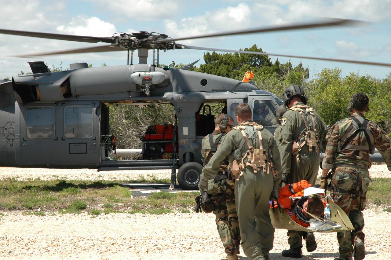 CAPE CANAVERAL, Fla. --  A group of NASA and contractor workers from Kennedy Space Center and other NASA centers, along with the Department of Defense, participate in a flight crew evacuation drill, also referred to as the Mode II/IV Simulation, from Launch Pad 39B. During the exercise, an emergency condition during launch countdown was simulated and participants did their parts to perform an emergency egress of the flight and ground crew. Fire Rescue and Closeout Crew workers transported the flight and ground crews to a triage site.  Simulated injuries were treated and those with serious injuries were evacuated by helicopter to local hospitals.  Photo credit: NASA/Jim Grossmann