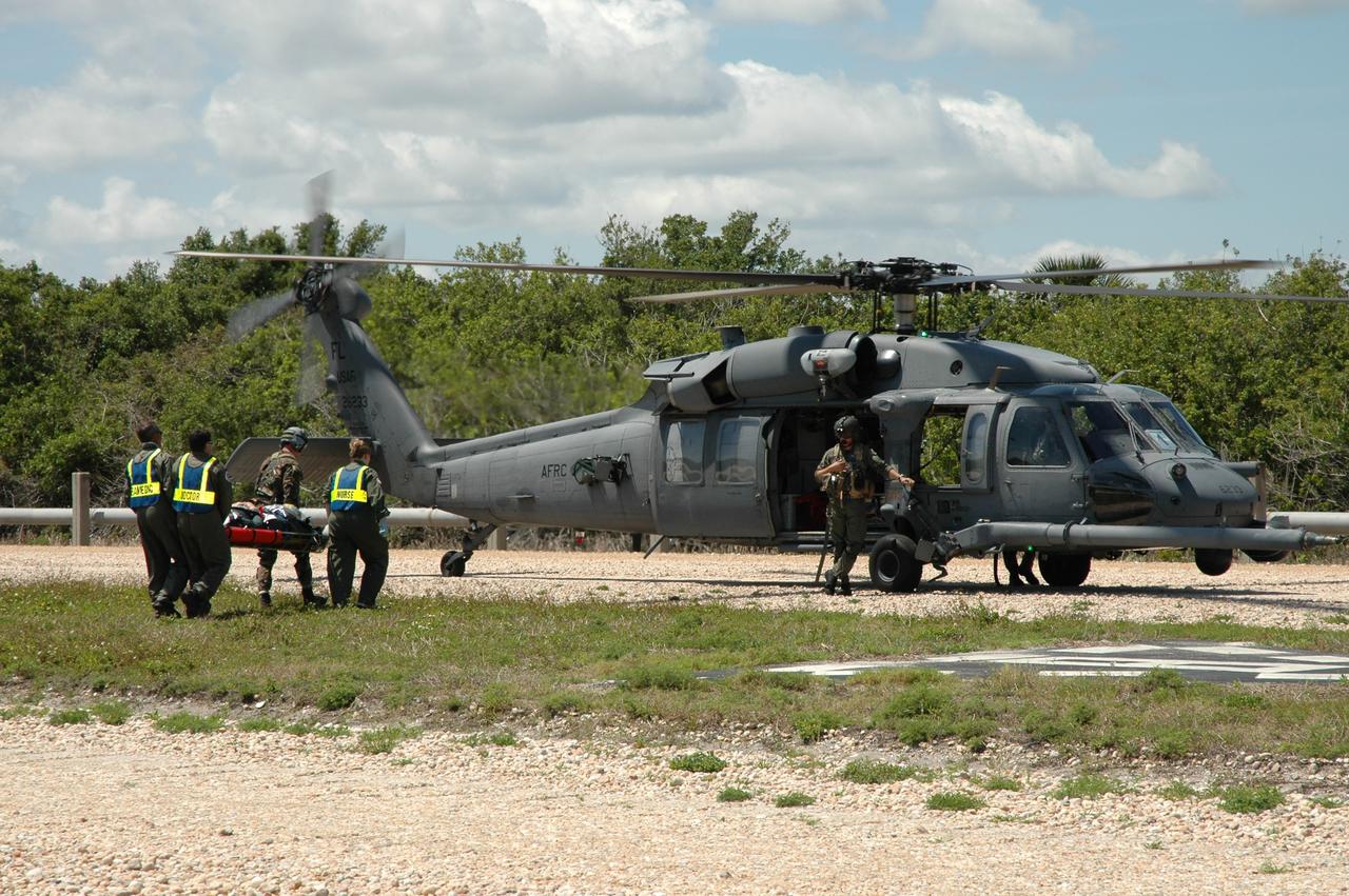 CAPE CANAVERAL, Fla. --  A group of NASA and contractor workers from Kennedy Space Center and other NASA centers, along with the Department of Defense, participate in a flight crew evacuation drill, also referred to as the Mode II/IV Simulation, from Launch Pad 39B. During the exercise, an emergency condition during launch countdown was simulated and participants did their parts to perform an emergency egress of the flight and ground crew. Fire Rescue and Closeout Crew workers transported the flight and ground crews to a triage site.  Simulated injuries were treated and those with serious injuries were evacuated by helicopter to local hospitals.  Photo credit: NASA/Jim Grossmann