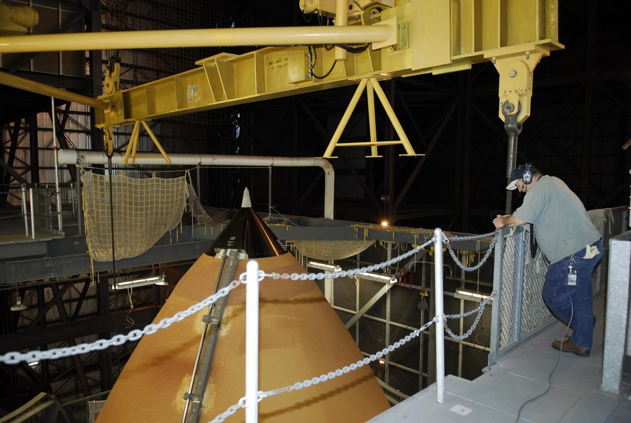CAPE CANAVERAL, Fla. -- Seen from an upper level in the Vehicle Assembly Building at NASA's Kennedy Space Center, the external tank for space shuttle Discovery is being lowered into high bay 3. The tank will be mated to the solid rocket boosters waiting below on the mobile launcher platform. Discovery is targeted to launch May 31 on the STS-124 mission to the International Space Station. On the mission, Discovery will transport the Kibo Japanese Experiment Module - Pressurized Module (JEM-PM) and the Japanese Remote Manipulator System (JEM-RMS) to the space station to add to the Kibo laboratory. Photo credit: NASA/Kim Shiflett