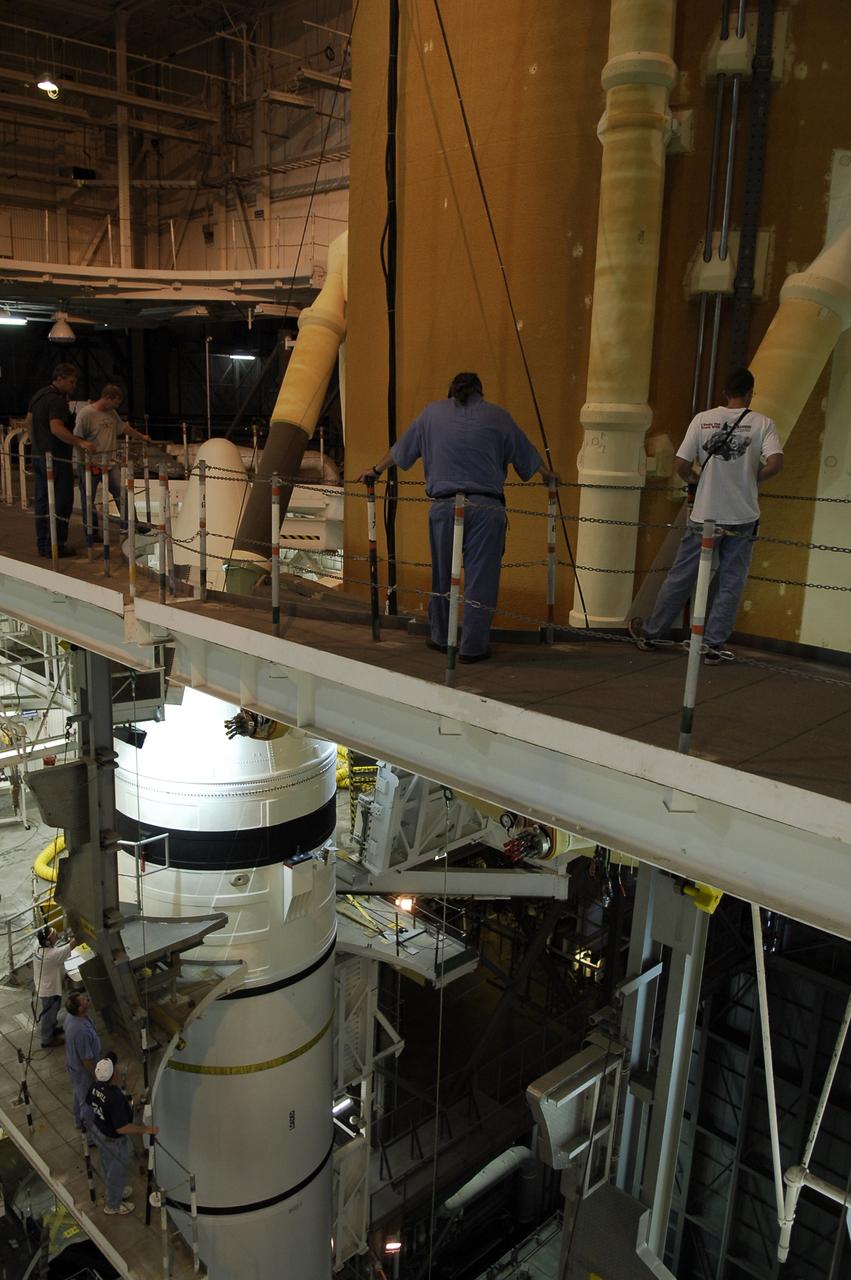 CAPE CANAVERAL, Fla. -- In the Vehicle Assembly Building at NASA's Kennedy Space Center, workers track the movement of space shuttle Discovery's external tank as it is lowered into high bay 3 between the solid rocket boosters waiting on the mobile launcher platform. The tank and rockets will be mated for the launch of Discovery on the STS-124 mission to the International Space Station, targeted for May 31. On the mission, Discovery will transport the Kibo Japanese Experiment Module - Pressurized Module (JEM-PM) and the Japanese Remote Manipulator System (JEM-RMS) to the space station to add to the Kibo laboratory. Photo credit: NASA/Kim Shiflett