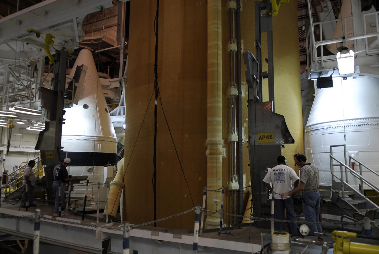 CAPE CANAVERAL, Fla. -- In the Vehicle Assembly Building at NASA's Kennedy Space Center, workers track the movement of space shuttle Discovery's external tank as it is lowered into high bay 3 between the solid rocket boosters waiting on the mobile launcher platform. The tank and rockets will be mated for the launch of Discovery on the STS-124 mission to the International Space Station, targeted for May 31. On the mission, Discovery will transport the Kibo Japanese Experiment Module - Pressurized Module (JEM-PM) and the Japanese Remote Manipulator System (JEM-RMS) to the space station to add to the Kibo laboratory. Photo credit: NASA/Kim Shiflett
