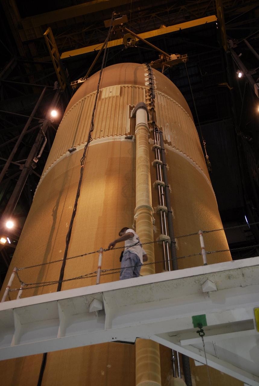 CAPE CANAVERAL, Fla. -- In the Vehicle Assembly Building at NASA's Kennedy Space Center, the external tank for space shuttle Discovery is being lowered into place in high bay 3 between the solid rocket boosters waiting on the mobile launcher platform. The tank will be mated to the boosters. Discovery is targeted to launch May 31 on the STS-124 mission to the International Space Station. On the mission, Discovery will transport the Kibo Japanese Experiment Module - Pressurized Module (JEM-PM) and the Japanese Remote Manipulator System (JEM-RMS) to the space station to add to the Kibo laboratory. Photo credit: NASA/Kim Shiflett